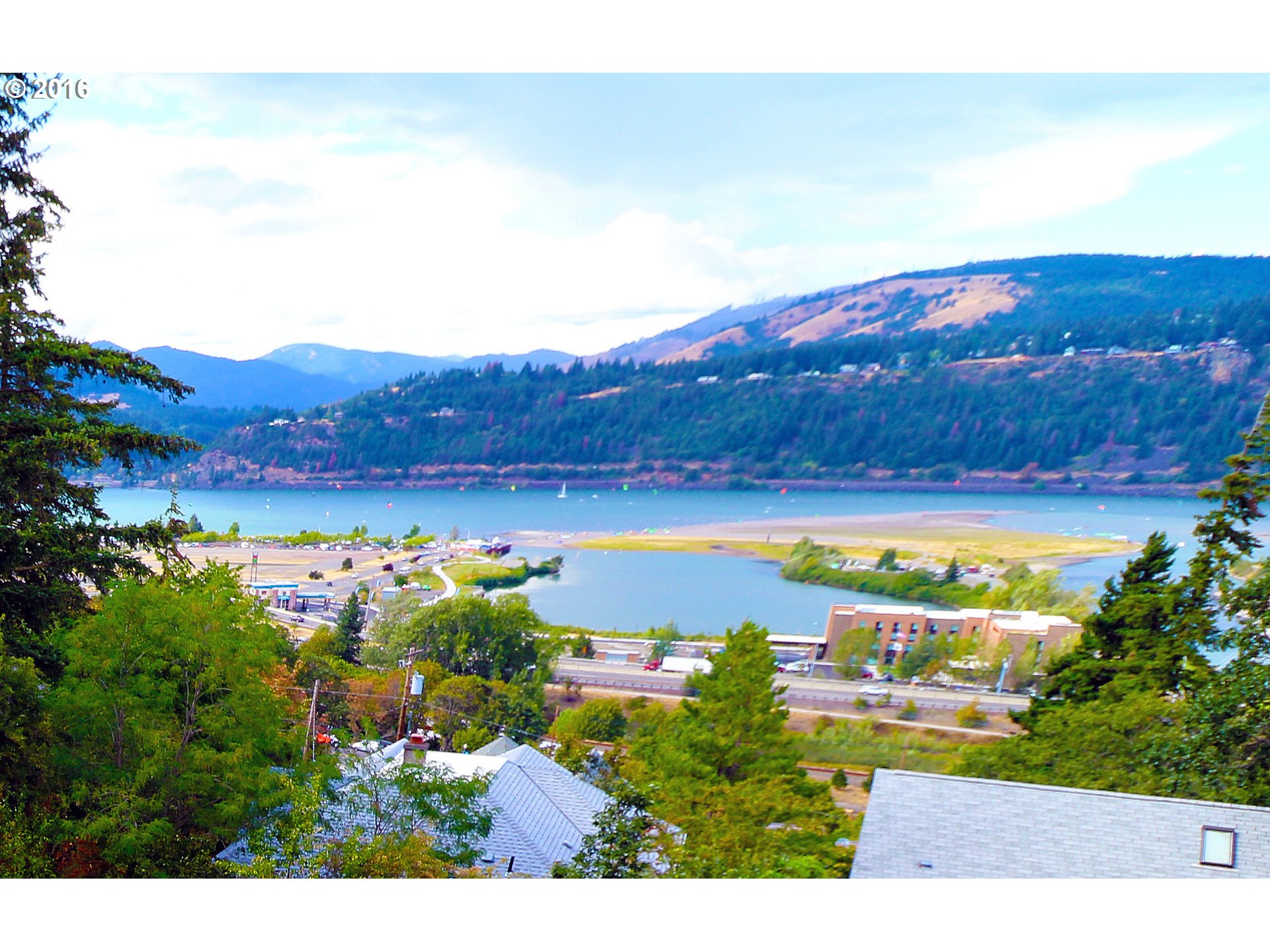 2 EUGENE Hood River, Oregon Over half an acre of spectacular view property zoned R3- You can see 180 degree view of the Columbia River, the Gorge, the mountains, even the individual wind surfers! The view is amazing! There is the possibility of building up to 6 view condos or attached houses, or leave the house that is there, and build 2 other homes on lower lots-lots of possibilities-buyer to do own due diligence! Just 4 minute walk to downtown Hood River.