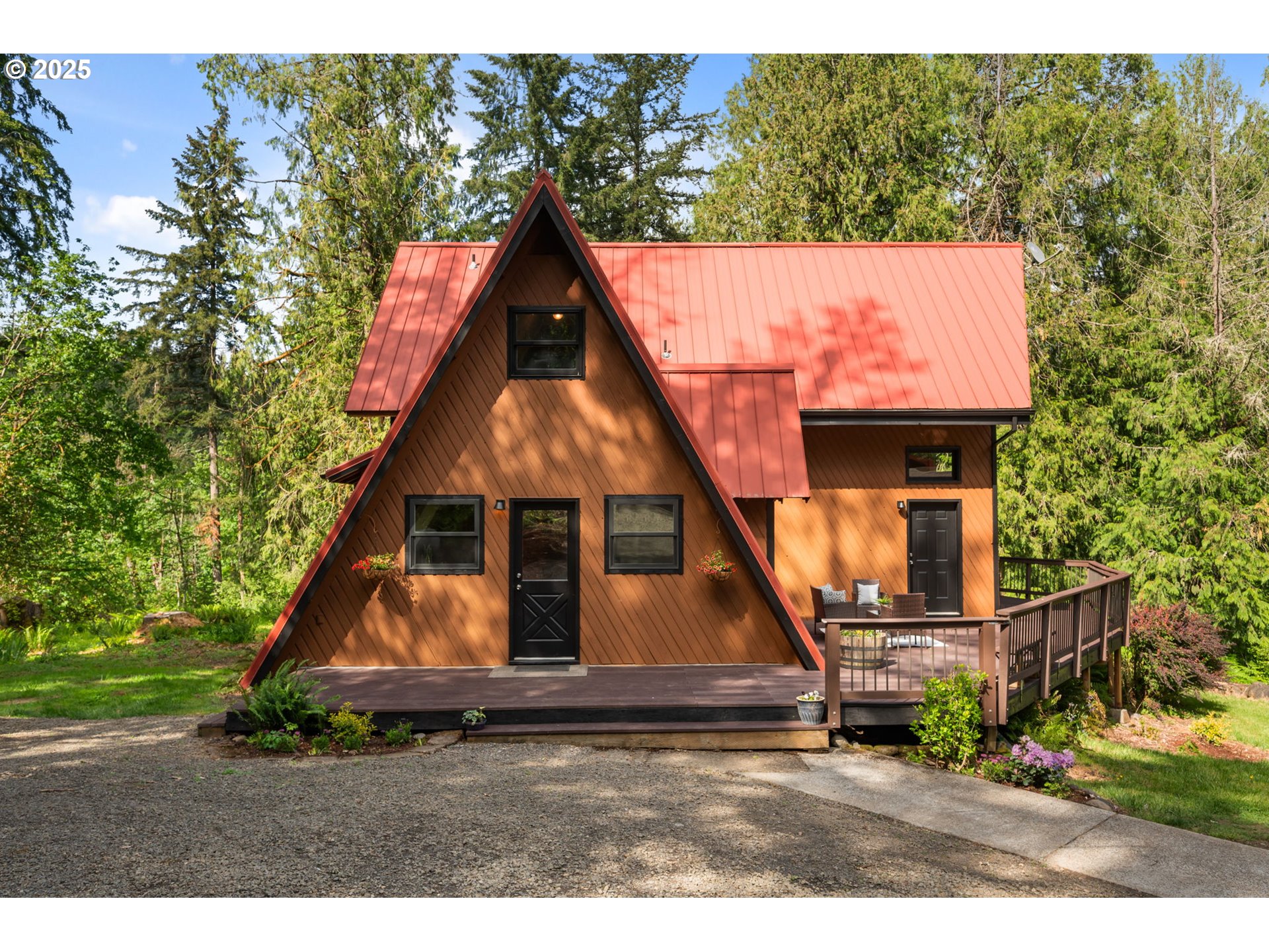 Tucked away on 4.64 acres and surrounded by tall evergreens, this private A-frame retreat offers the peaceful, wooded setting that’s hard to find. With quiet all around and forest views from nearly every window, it’s a perfect mix of charm, seclusion, and flexibility. The main house offers 1,656 sq ft of comfortable living space full of character. The kitchen features custom knotty pine cabinetry, a cook island, and a cozy dining nook. Vaulted ceilings in the living room with large windows bringing in natural light, and a gas fireplace with a stone surround adds warmth. The main level includes a bedroom and full bath, while upstairs you’ll find two more bedrooms, a second full bath, and an open loft. One of the upstairs bedrooms is ideal for a home office, guest room, or creative space. Across the driveway, half of the detached garage has been converted into a fully finished 1,075 sq ft in-law suite with its own entrance. It includes two bedrooms, a full kitchen, bathroom, newer roof, new electric water heater, and shares the upgraded well filtration system with the main home. Recent updates to the main house include fresh exterior paint, interior touch-up painting, new LVP flooring on the lower level, a new electric water heater, and a brand new septic system going in serving both dwellings. The grounds have been thoughtfully cleared and landscaped to improve curb appeal while keeping the natural woodland feel. Set up for multigenerational living or weekend guests, this rare property offers both a move-in-ready main home and a separate finished guest space in a quiet, forested setting. Whether you're enjoying coffee on the front deck, hosting in the open kitchen, or exploring the surrounding trees, this home delivers the peaceful lifestyle you've been looking for. Schedule your showing today!