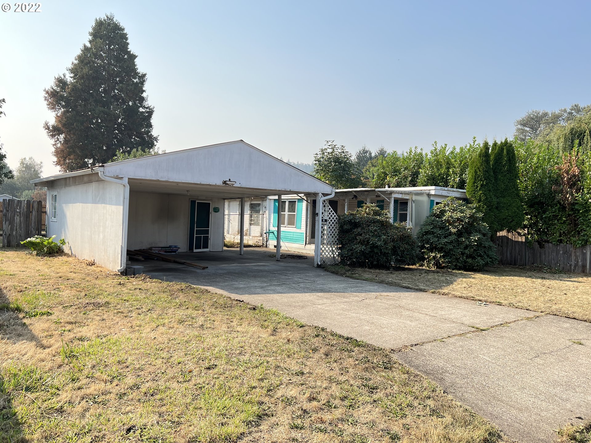 Replace or remodel? Older single wide that can be fixed to be low cost living, or replaced with a new home.  Cash only due to age and condition of home, or land home package for a new home.  Serviced by SUB, but also on septic. Storage building along with double carport with small studio with electricity. Quiet neighborhood near Dorris Ranch. Make this your new home!