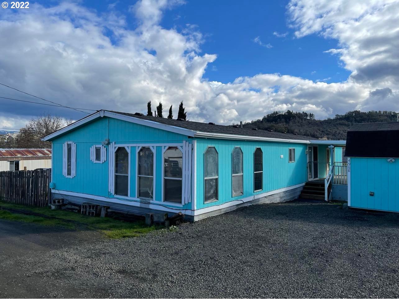 Spacious double wide manufactured home on its own lot featuring high ceilings, an open floor plan, formal living and dining/den loads of storage and a large laundry room. There is a large master suite with dual closets, and an easy walk in shower. All of this on a fenced lot with filtered views of the hills. Move in and make this your own!