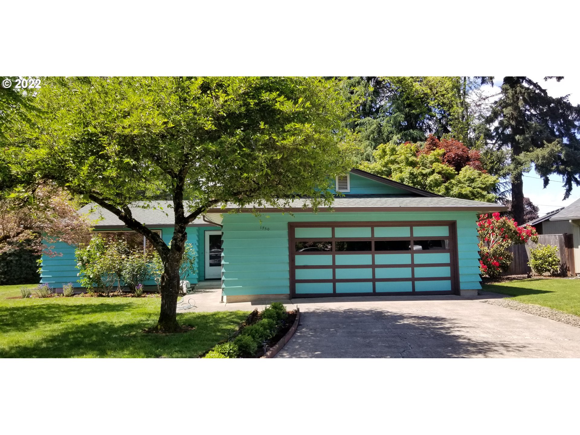 Lovely mid-century home on a quiet cul-de-sac. This home boasts original hardwoods, 2 fireplaces and a spacious fenced yard with mature landscape. Primary bedroom with bath (and don't miss the "hobbit" door in the closet!)Kitchen and adjacent dining area offer built in propane cooktop, built in oven and a large built in china cabinet for storage. Home has fresh interior paint and a new roof to be installed. Large 2 car garage. Convenient to schools and shopping. This home has a lot to offer!