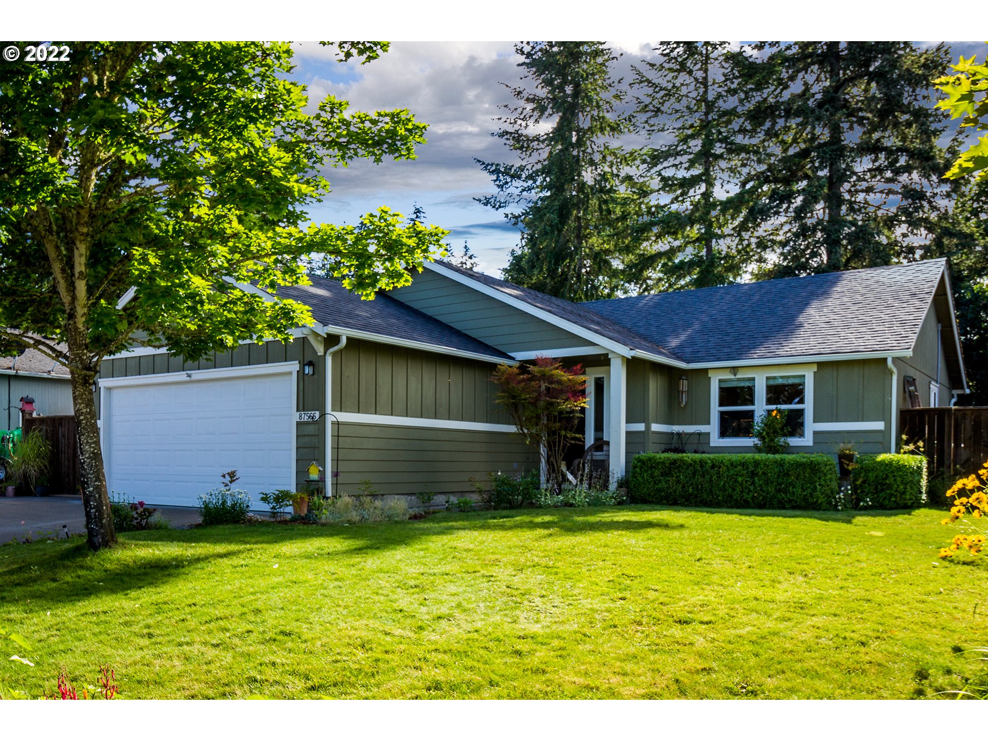Newer construction with a private setting located in a quiet neighborhood! Inside, enjoy vaulted ceilings, updated bamboo flooring, cabinetry, SS appliances, primary bedroom and private bathroom. Outside you'll find a large covered patio, outdoor living and landscape improvements, a surrounding fence, privacy treeline, toolshed, extra wide garage and greenhouse or camper parking! Take in the hand-selected planted flowers as you enter a home that provides ideal amenities!