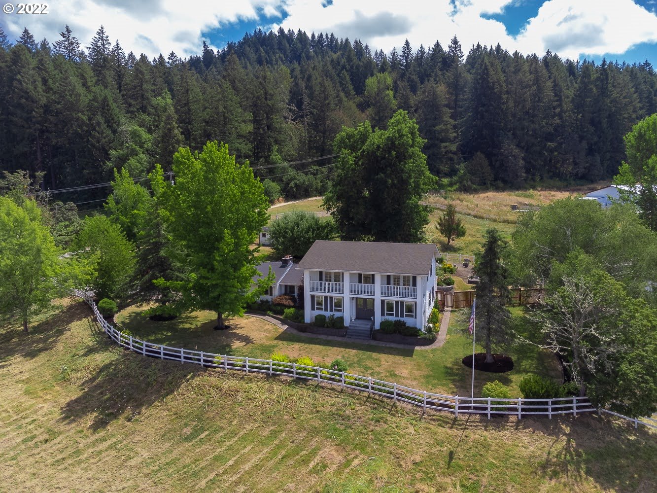 Stunning home on 5.14 usable acres. Bright kitchen with granite countertops, tile, SS appliances, and spacious pantry. Large primary suite w/custom tile shower, double sinks, WI closet, and balcony overlooking the property. Beautiful garden and deck for entertaining. Barn and 2 additional outbuildings w/power. Cross-fenced pastures for horses. Not in a flood zone, the well has never gone dry and low taxes. Call your agent today for a showing!