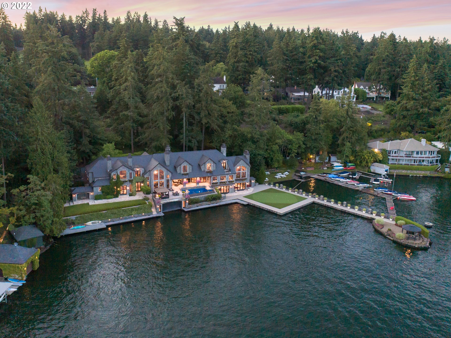 Awe-inspiring custom living awaits on a phenomenal stretch of coveted Oswego Lake!Step inside to unparalleled craftsmanship:grand architecture, elevator, in-home 2-lift boathouse, billiards hall, theater, gym w/sauna, opulent bdrm suites & slate/basalt/copper exterior.Throw open wall of doors to sprawling stone terraces w/infinity pool & spa, waterfront putting green, private dock, island fire pit & endless water sports.This is Oregon's premiere private lakefront estate near luxurious amenities.