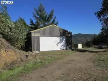 Build your dream home on this beautiful 57+ acres of heaven.  Have total privacy with rolling hills, meadows with a large variety of trees to call your own. Includes a private drive to home site where fixer manufactured home (of no value) sits and a 24x24 shop w/220. Also there are several potential home sites to build your dream home.