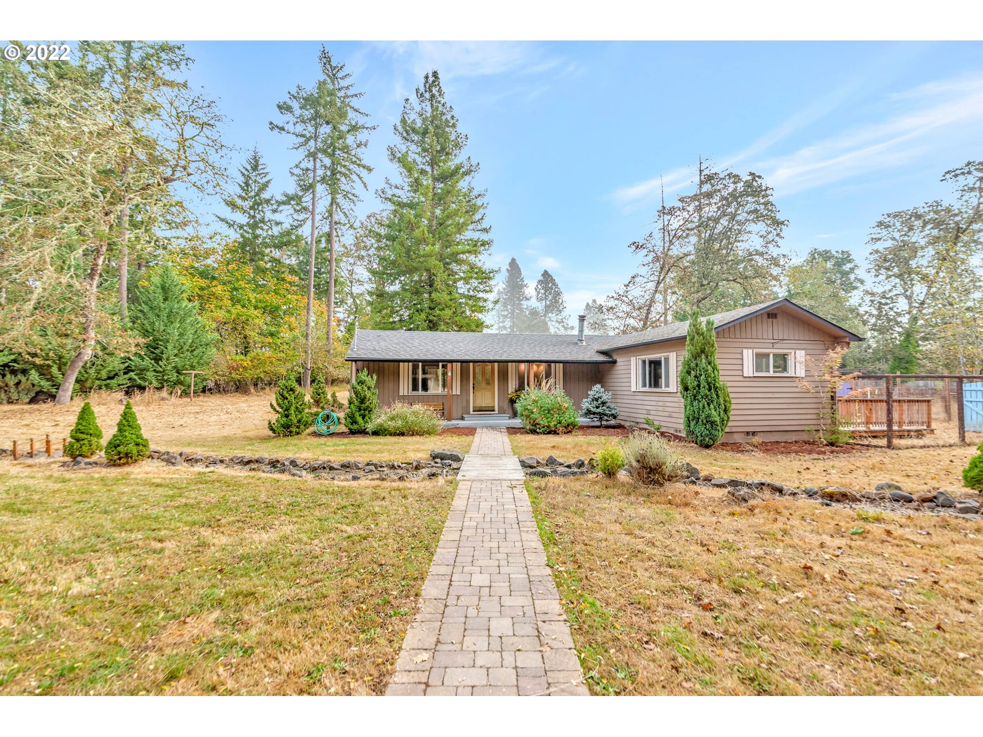 Come see this Homesteader's and Hobby-Farmer's dream! Move-in ready home with open floor plan and great separation of space.  Granite countertops and hickory cabinets in kitchen, updated bathroom and new flooring throughout. Private and Peaceful acreage with a covered front porch, fully fenced garden, fruit trees, and gardening shed.  Back deck off the Master bedroom opens onto garden area.  Only 15 minutes to Eugene.  This property is priced to sell and won't last long!