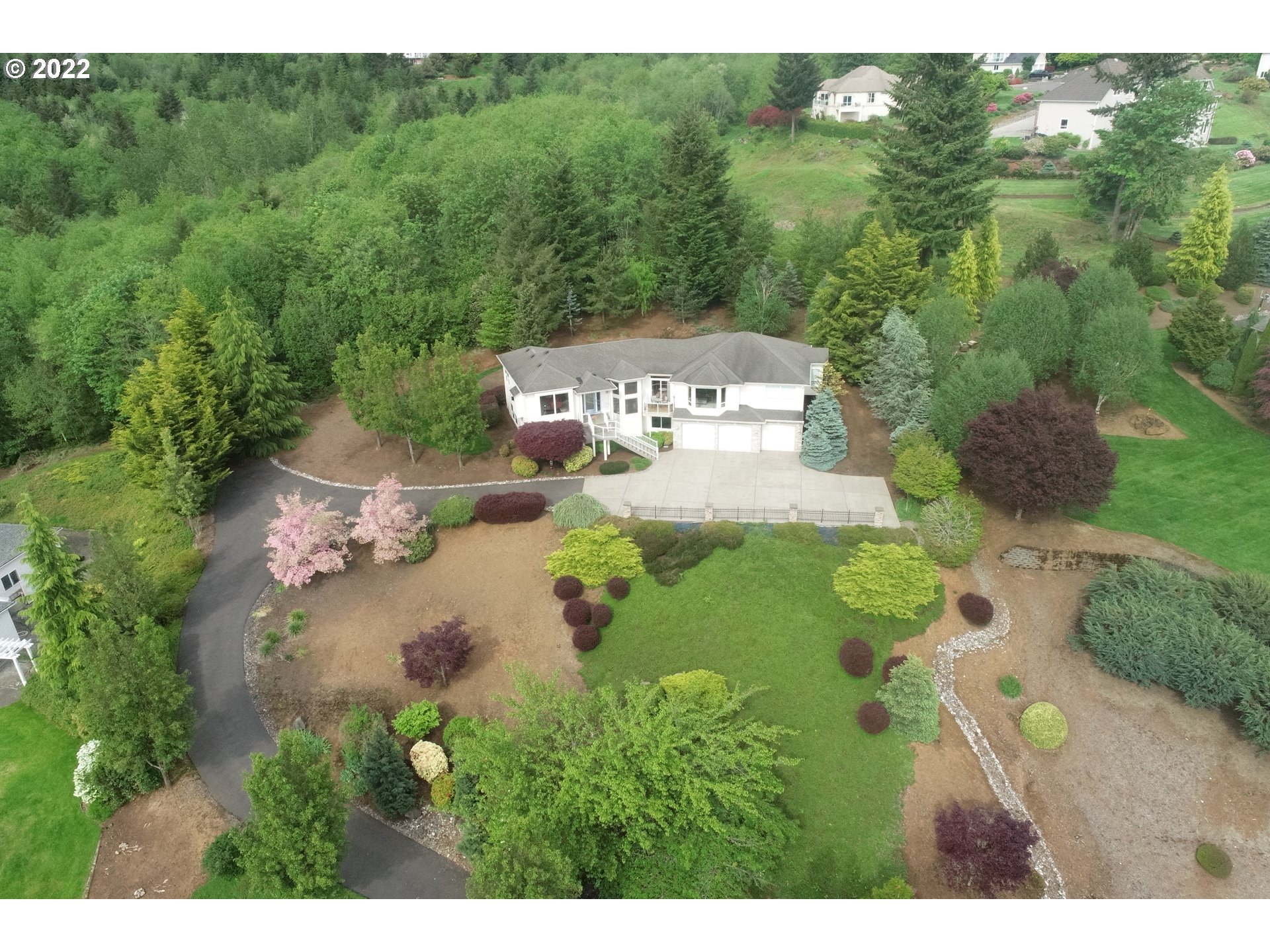 Million dollar views from all over this amazing home! Enjoy this custom home sitting on just over 1 acre in Summer Hills with miles of trails and green space providing privacy all around. Light and bright throughout. Beautiful living room, main floor office or extra bedroom. Spacious kitchen opens to large family room. Wake to spectacular views from your main floor primary suite. On lower level are two more bedrooms, bonus room space plus extra room off garage. Come take in the views!