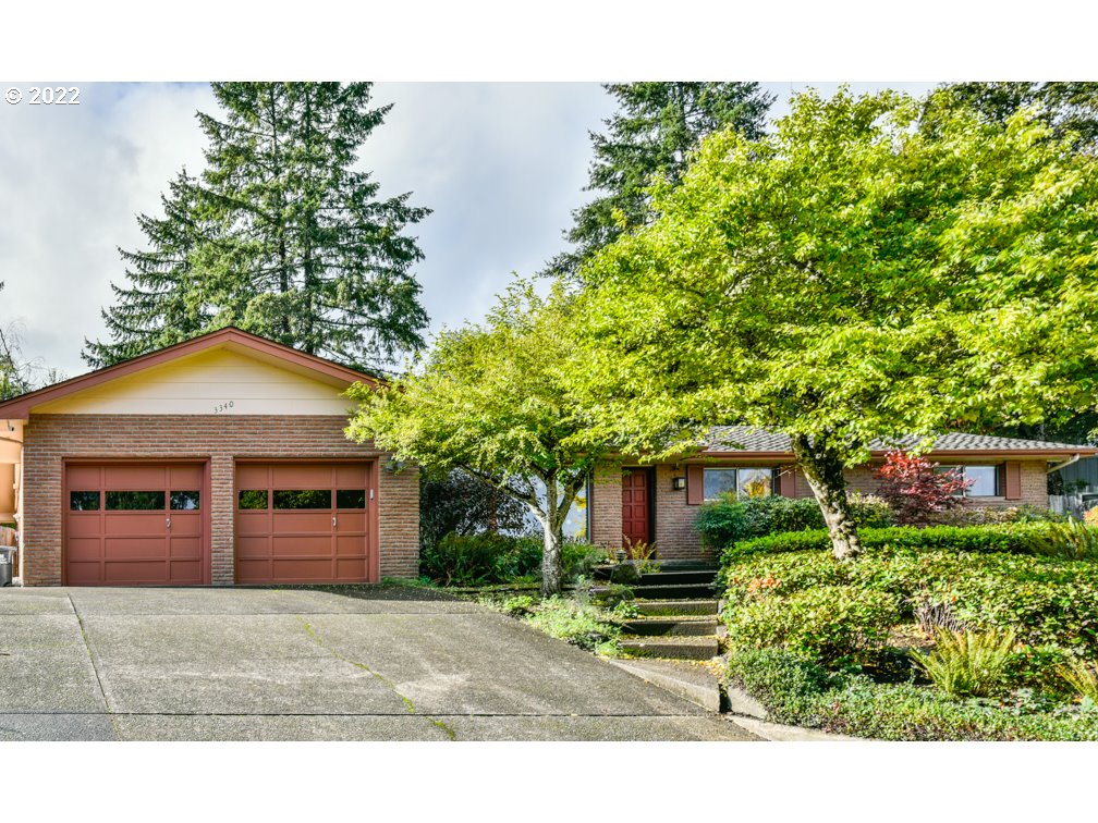 SW Hills-Light and bright single level home with views! Spacious living room w/ fireplace and walls of windows, family/dining/kitchen w/ fireplace, bar, double wall ovens, large windows w/ private backyard views and sunroom. Primary bedroom w/ slider to back patio and remodeled bathroom. Updates include; recessed lighting, new cooktop, remodeled full and half baths, amazing landscaping and tasteful see-through fencing for pets. Close to Friendly St hub with restaurants, natural foods and more.