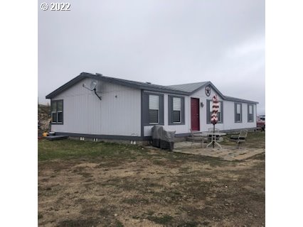 Nice manufactured 4 bed 2 bath home on 13.25 acres, 1500 Square ft. shop and a pond all within the enclosed fenced property. Beautiful views it's a must-see piece of property. Within minutes of I-84 North or South. Qualifies for 5acres to subdivide. 7 acres of water rights, ALL TOOLS TRACTOR ARE INCLUDE WITH SALE, MAJOR PRICE IMPROVEMENT REDUCED TO 399,900.00