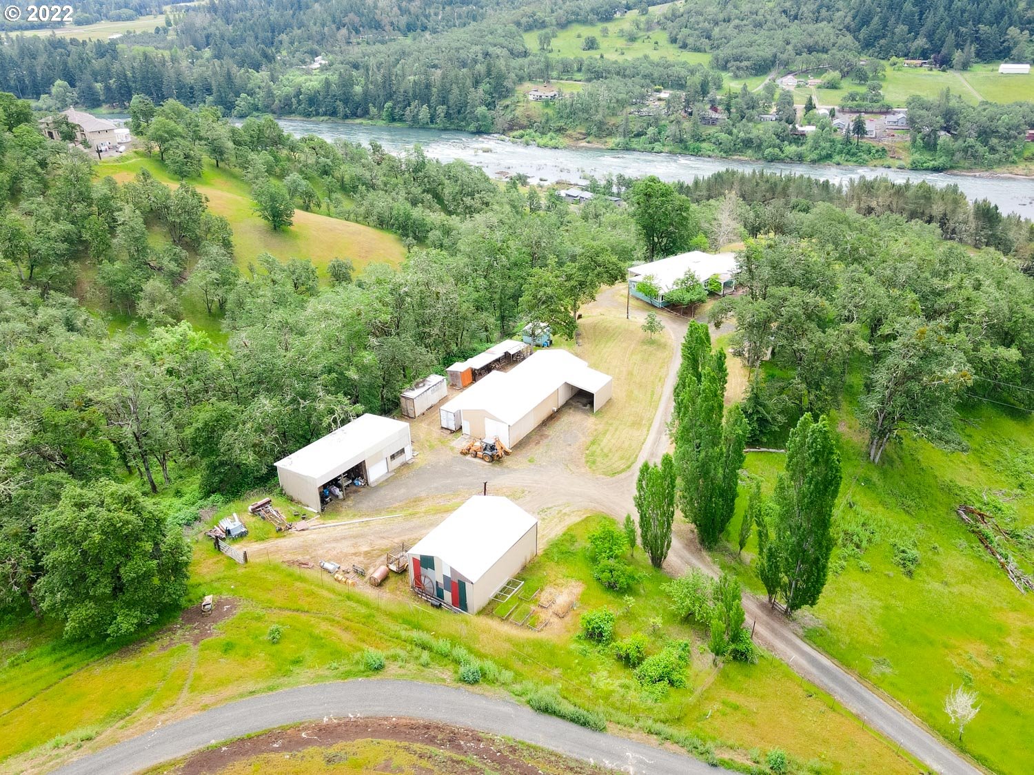 Unique Hill Top Ranch in highly desired location, includes well maintained spacious home with vaulted ceilings and gorgeous views of the N. Umpqua river, hills & forest lands. 141 acres (currently running cattle keeps property taxes at a lower rate) includes guest studio, 2 shops, air strip w/2 hangers, RV storage, fenced pastures and more. Land and store your planes at home OR use the hangars & pastureland for cattle or horses. Call today for viewing!