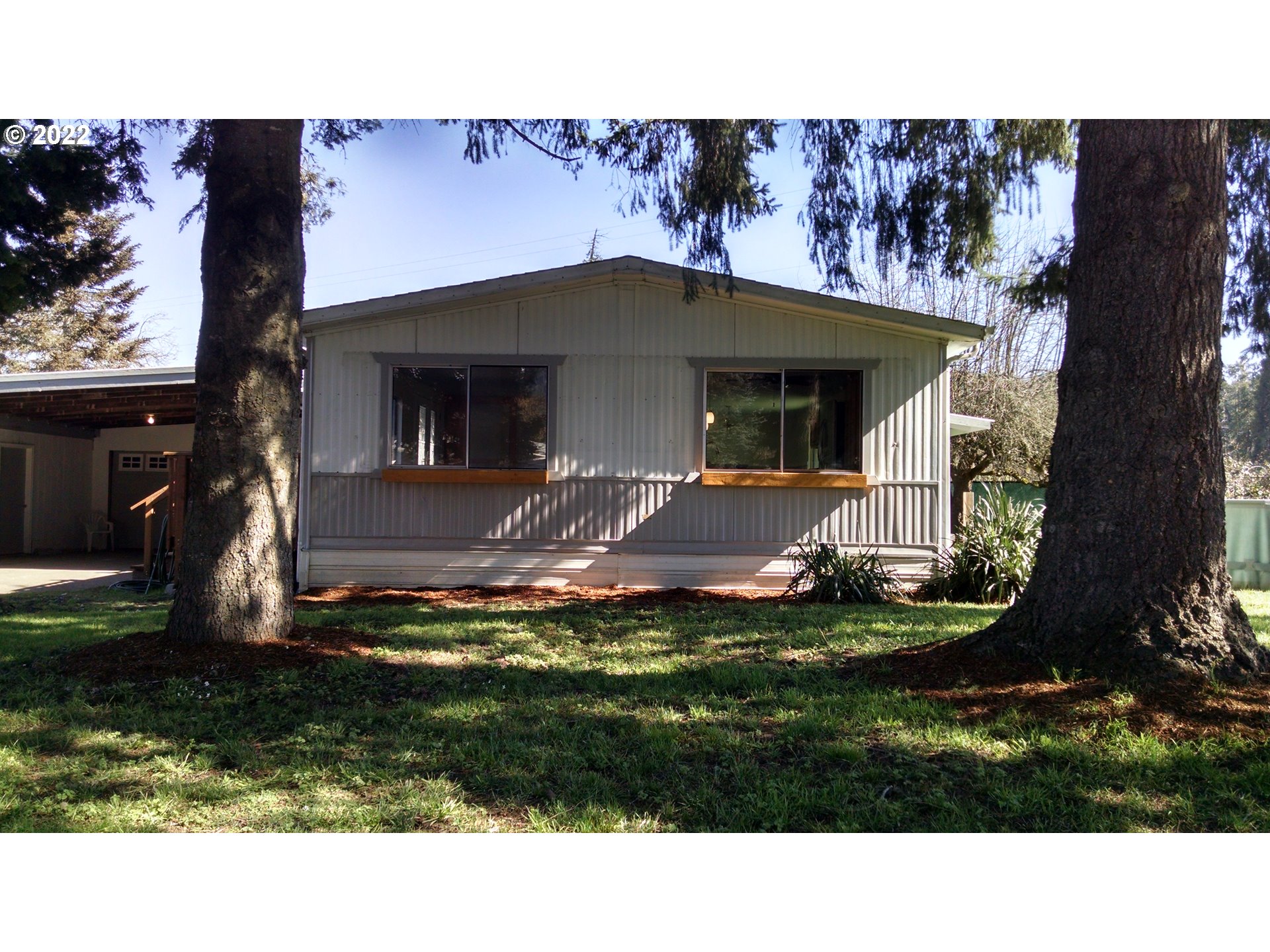 Newly updated 3bd / 2ba manuf on 2 lots with additional 400 sf stick built shop/storage space - 2 car garage + 2 car carport - nice quiet setting with neighboring Dorris ranch - won't last
