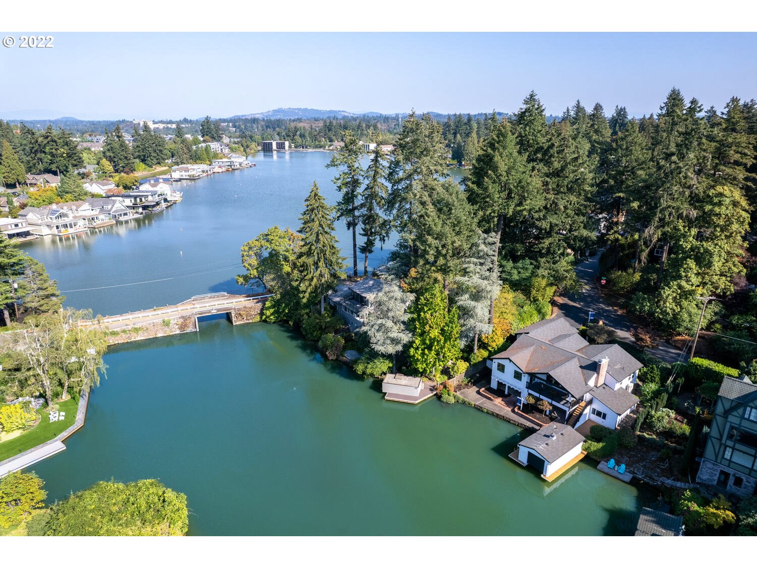 The coveted lakefront lifestyle awaits in this sleekly remodeled main level living refuge on Oswego Lake's Half Moon Bay!Step out your back door & into the lake w/private dock,boathouse,idyllic patios & covered deck.Enjoy gorgeous views from virtually every room, mid-century mod finishes & plank floors, picture windows & a wonderful open floor plan. Sunsets on the lake w/your favorite libation, tranquil waterfront living & a short stroll to vibrant downtown LO dining, shopping & farmer's market!