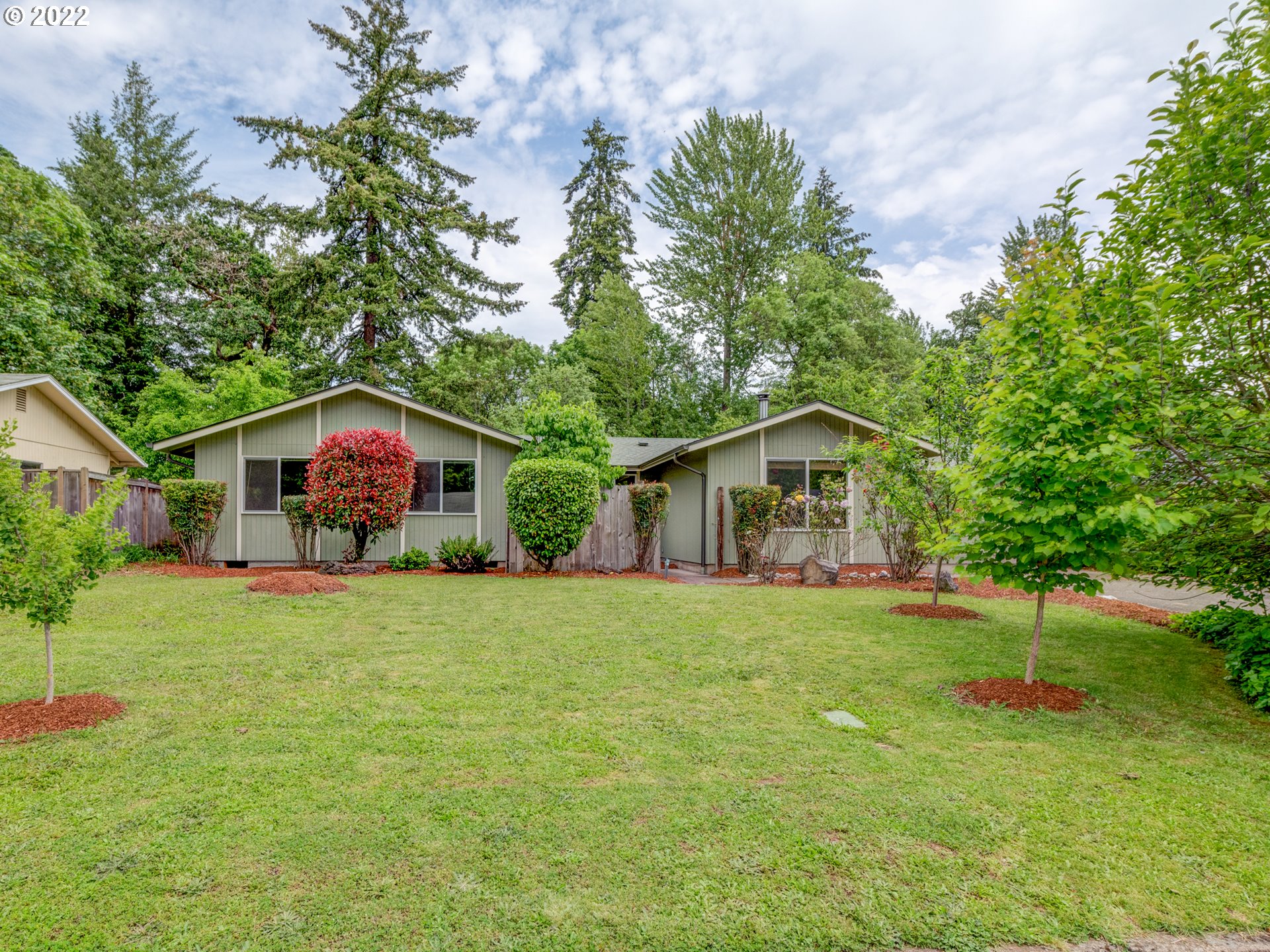 One-level on private, 1/3 acre lot, bordered by creek & green space, w/garden & low county taxes! Home has solid surface flooring, separate family room w/woodstove, newer washer/dryer & stainless refrigerator, newer roof, gutters, & vinyl windows, & pass through garage. Large backyard offers a covered patio, berries, fruit & nut trees, tons of bulbs, & outbuilding on slab w/electricity. Quiet neighborhood w/new construction & updated homes, low traffic street, near bike path, parks & playground.