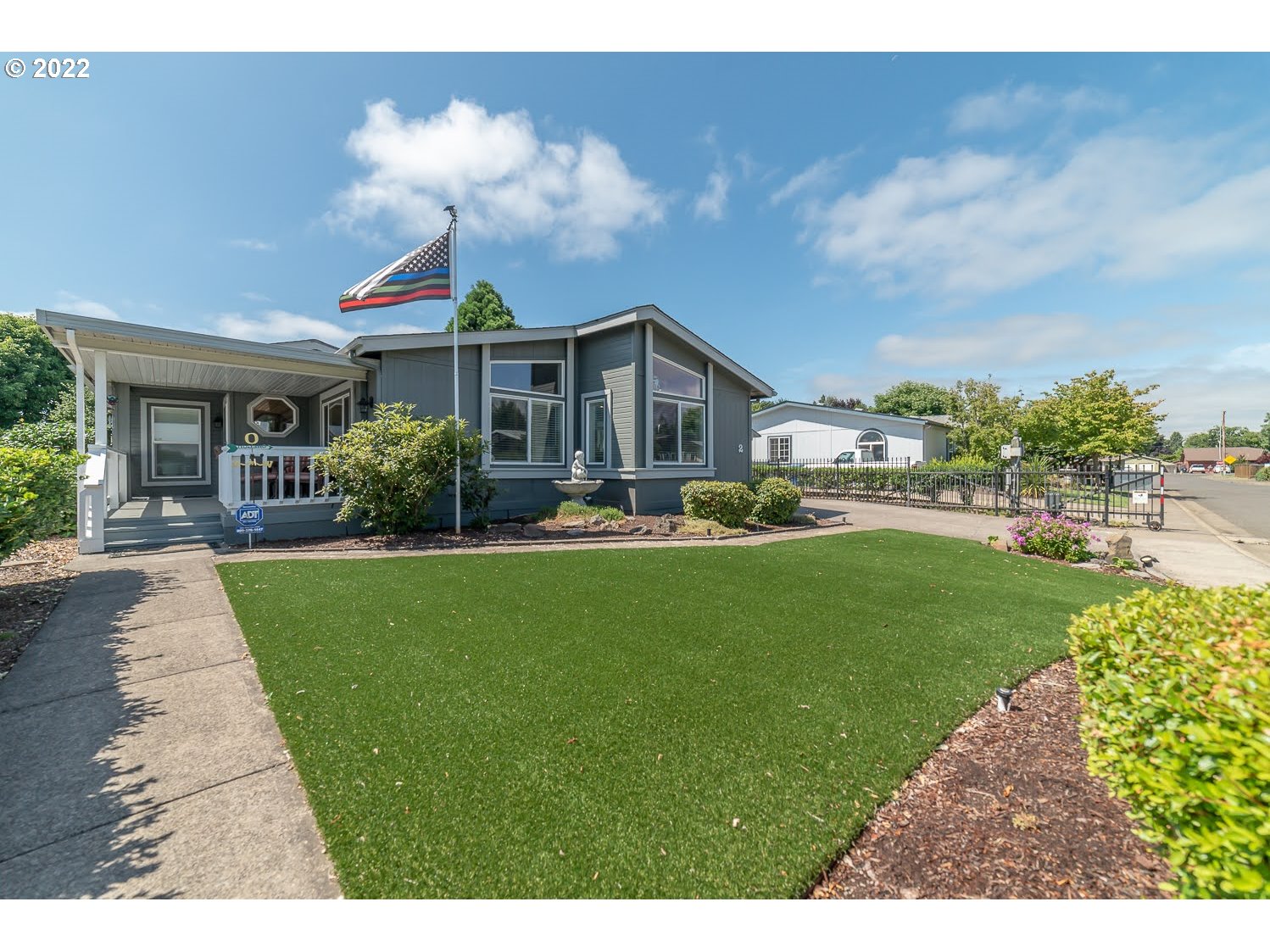 Beautiful Manufactured home in sought-after 55+ Camelot Village! This spacious, light and bright FSB area home has been meticulously maintained and updated throughout. Features include an updated kitchen with newer appliances, vaulted ceilings, a large primary bedroom suite w/vanity area, a newer furnace/compressor, newer exterior paint, low-maintenance front & backyard, and good-sized shop/storage area. The community has a low monthly space rent of 457.00. Clubhouse, indoor pool, and more!