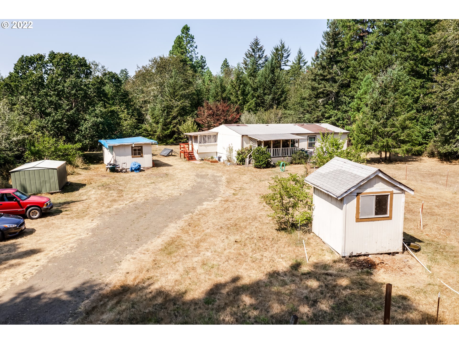 Over 4.5 Acres privately tucked away and hidden in the trees.  Private Country feeling and still just minutes from Eugene with Down Town Veneta just down the road. Live in the Manufactured Home, while you build your Beautiful Dream Home.