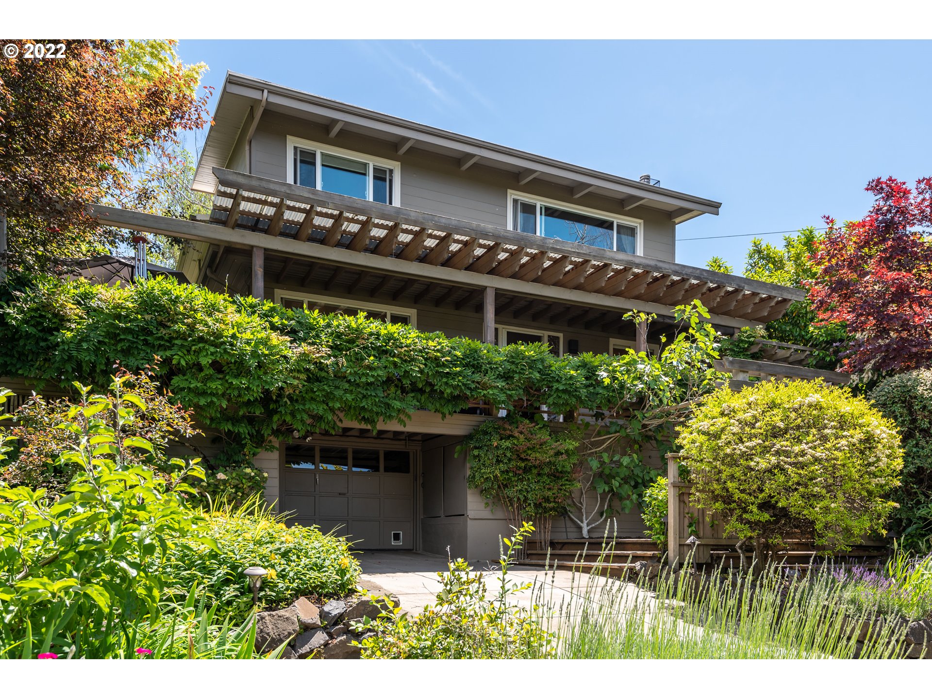 Work from home in this beautifully updated mid-century charmer. Panoramic views and year-round garden w/mature fruit trees. Spacious LR with gorgeous wood floors, gas fpl, newer kitchen and bathroom w/heated floors, new hot water heater/roof 2020. Sizable main bedroom w/vaulted ceilings, gas fpl & lovely views. Backyard patio, hot tub, wrap around deck. Possible separate living with private entrance.