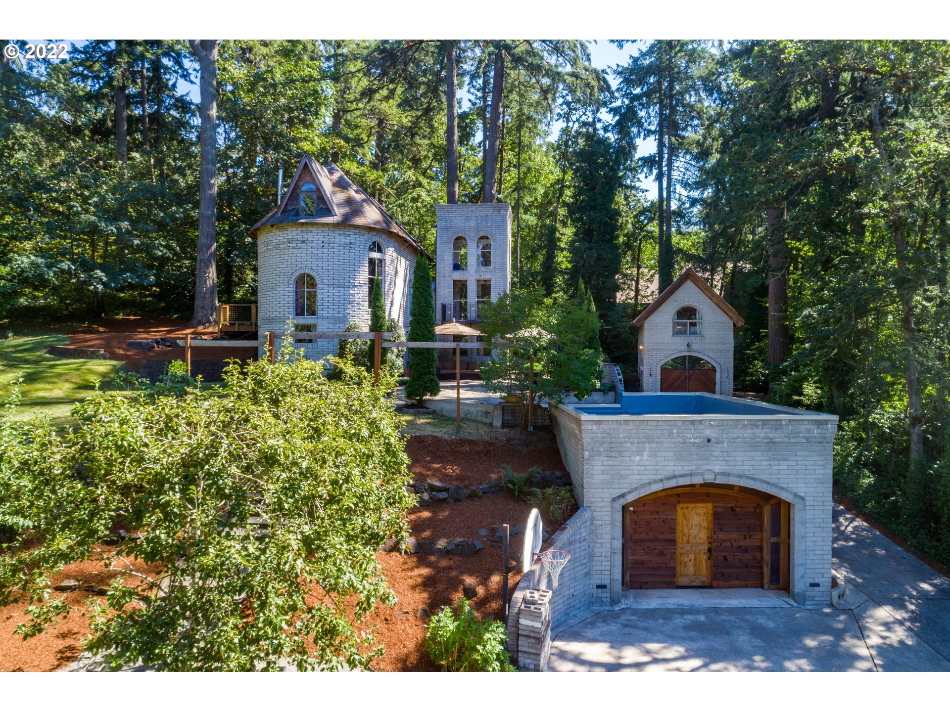 Live In A Castle With Medieval Charm & 2 Active Airbnbs Near Laurelwood, Hendricks & UO! Wood beams/ceilings, open concept great room, 2 loft beds w/ built-ins, 1 bath & 2 story tower in main area. Lower level has studio apartment or family room w/ sep entrance, built-in bed, kitchenette & full bath. Storybook detached cottage has loft bed, bathroom & kitchenette. 3 fireplaces & ductless heat/cool. Private setting on 1/3 acre w/ detached garage & multiple outdoor space in fantastic neighborhood!