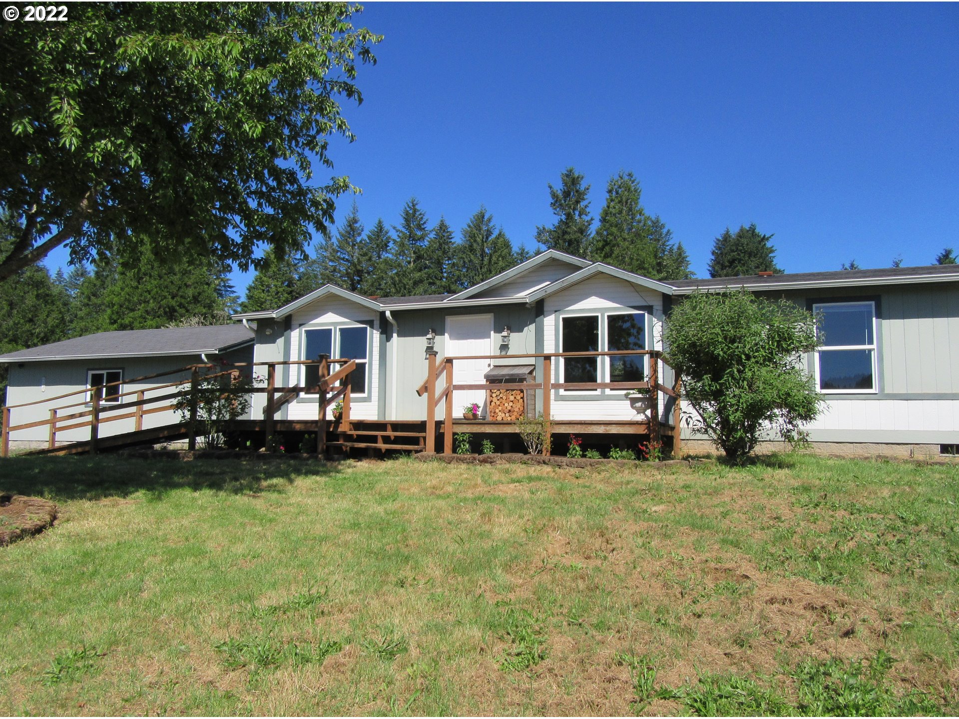Sitting on 2+ open, usable acres, this 3 bedroom, 2 bath home built in 2002 has gorgeous mountain and valley views from all three bedrooms, living room, and dining room. Designed for comfortable living and easy entertaining, the home offers excellent separation of space, family room with wood-burning fireplace, and spacious front deck. Detached 528 sq ft 2-car garage, RV pad, ample parking. The gently sloping, open acreage is ideal for gardens, animals, and fun. Brand new private well 16 gpm.