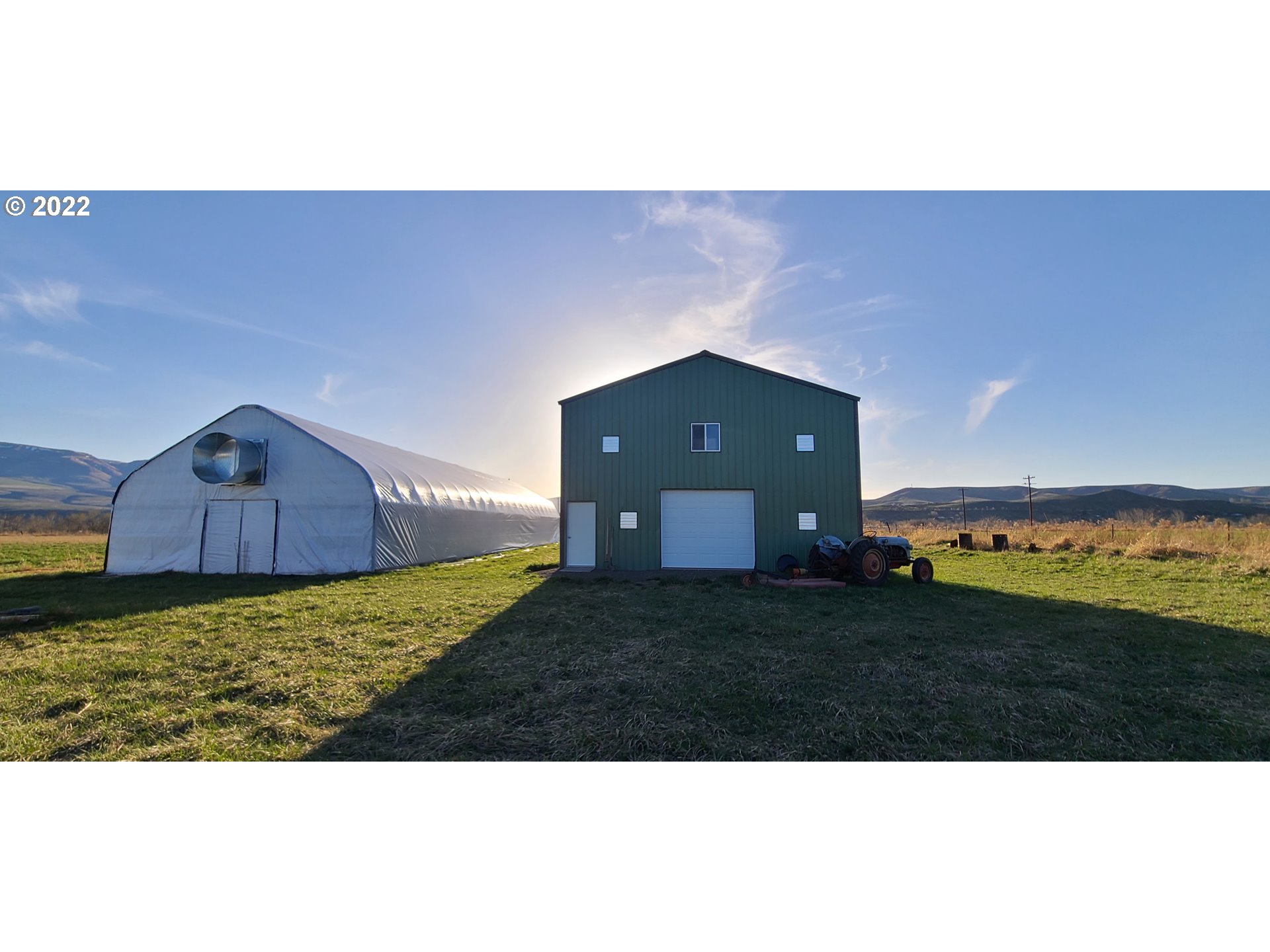 Rare 5 acre+/-irrigated buildable acreage outside of Richland w/ 30x36 two story shop with 10' over hang for covered RV parking. 100 amp elect service.  Electric installed in fully insulated shop. 100x30 vented green house with clear & shade covers. Panorama views in the heart of recreation paradise. Convert 2nd story into living quarters and have shop/garage below or have awesome shop and rec. vehicle storage. Or build. Come and enjoy the abundance our community has to offer.