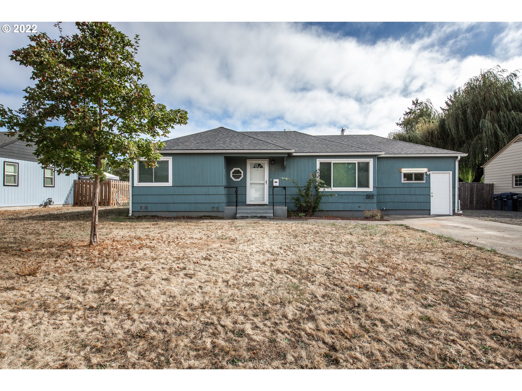 Well cared for single story home featuring original hardwood flooring, ductless heat pump, deep closets, a charming vintage style galley kitchen, a large converted bonus room, large back yard, low maintenance cedar siding, RV parking, a large shed and massive fenced backyard with fruit trees. All of this with easy quick access to downtown. Dont miss out on this move in ready charming home! Open house 10/15 from 12-2!