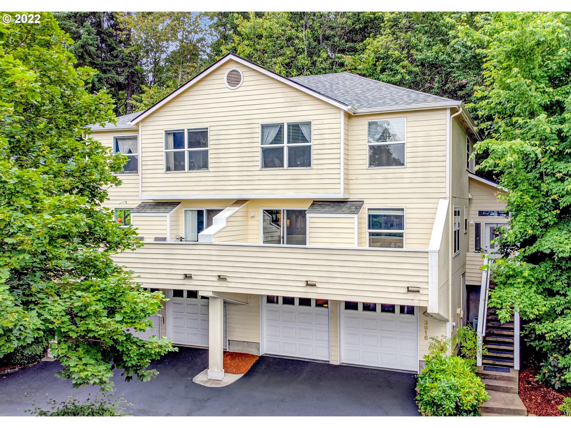 South Hills Stunner Nestled in Trees Overlooking Eugene! Townhouse-style, end-unit condo w/only 1 shared wall. Main level family room w/fireplace & sunny, 160 sq ft balcony, kitchen w/stainless appliances & gas cooking, half bath, & access to private, fully fenced backyard. Oversized, upper-level landing (could be office or fitness nook!) connects vaulted primary suite, guest bedroom, 2nd full bath, & conveniently located utility space (+ washer/dryer). Oversized 2-car garage & 6x8 storage nook!
