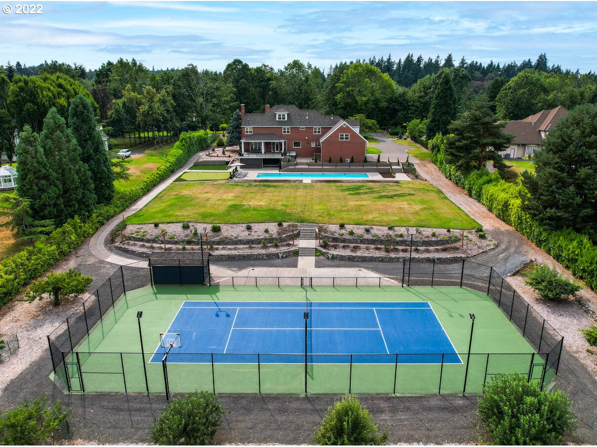 Have it all in this tranquil 2.28 acre wellness estate exuding joie de vivre w/25 yd salt lap pool, putting grn, tennis/sport court & verdant grounds w/quick access to I205 & Oregon's famed wine country! Handsome interior w/hi ceilings, window walls & rich hardwoods, chef's gourmet kitchen great room, 2 main floor offices for remote solutions & palatial primary suite wing w/dual walk-in closets.Many versatile flex spaces inc 2 bonus rooms + theater rm w/space for golf simulator & extra storage!