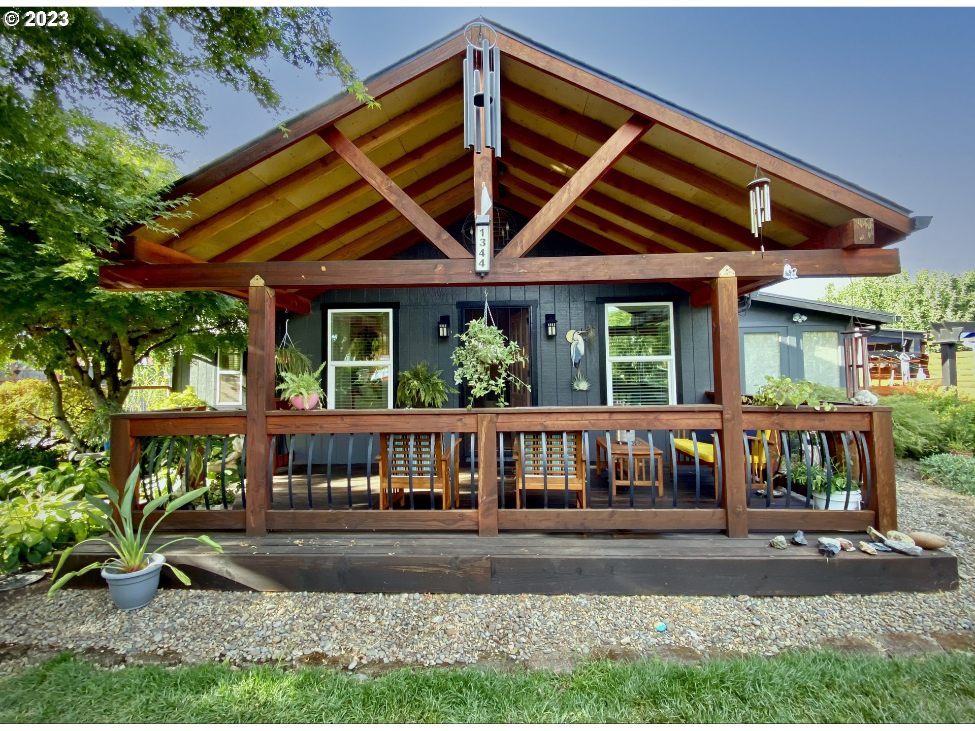 Enjoy the lush view of foliage while relaxing on your large craftsman porch! A green haven in the front and back of this property creates a serene seasonal view of flowers, fruits, and vegetables. This Hayden Bridge home is a gardening delight!  New roofs, new flooring, granite kitchen countertops, ductless air, gas fireplace. ADU behind the main house has a kitchen + bathroom, it is under 200 sq feet. Very large detached shop/garage is divided into sections for storage and other purposes. Beautiful front porch and tall wood backyard fencing were new a few years ago. Loads of parking in the extremely long driveway. Room for RV and boat parking. Main bedroom has its own porch and entrance. Close to bike paths, shopping, schools, and Riverbend Hospital. Well cared for unique home, schedule to see it today! *Note, most of the pictures were taken this summer. The house has 2 bedrooms and 1 office, the ADU is what adds the 3rd bedroom.