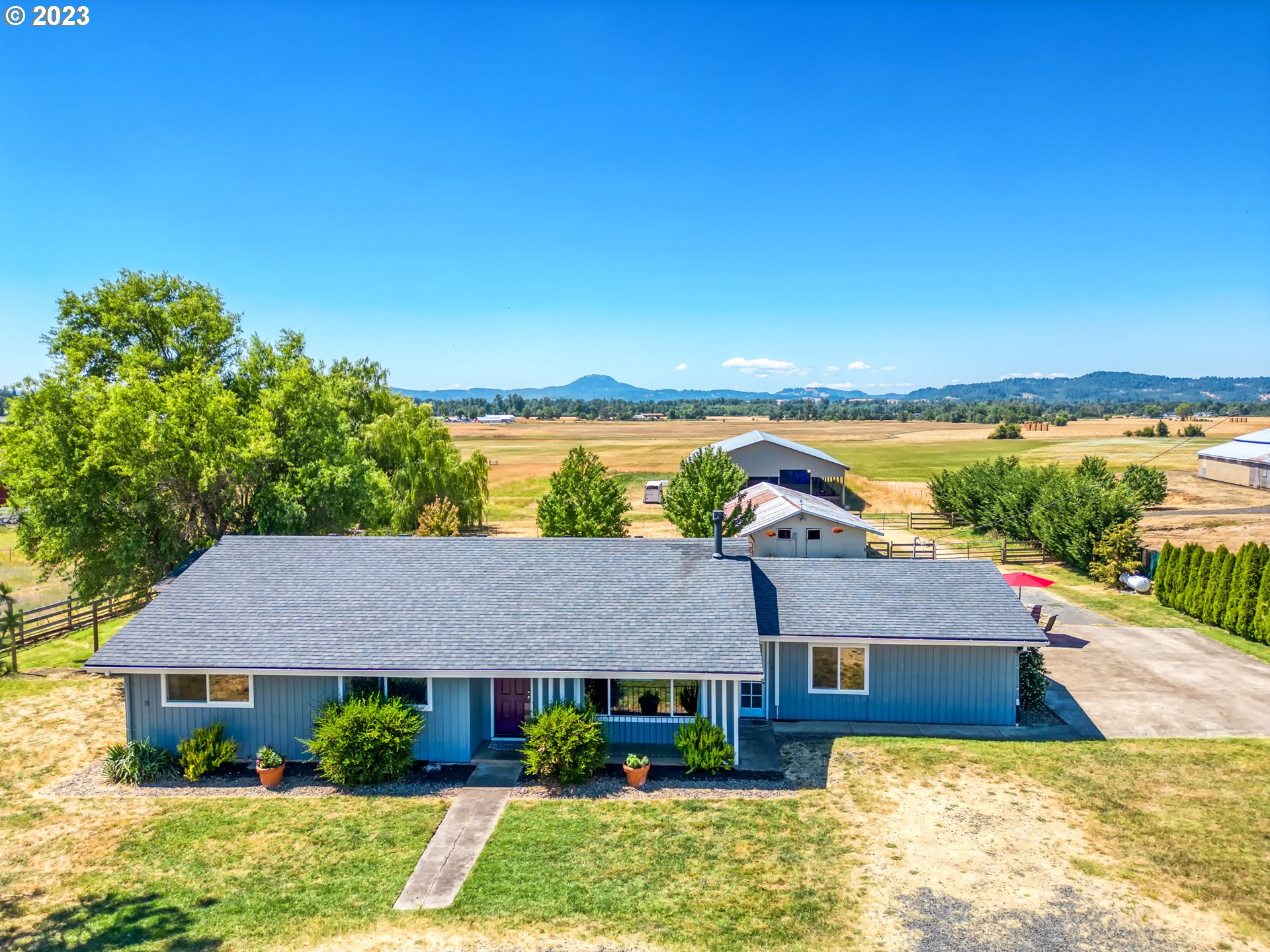 Beautifully updated and remodeled with an open floorplan. Primary suite offers privacy and a view of the pastures. Situated on 15 acres of land, it offers ample space for your animals or storage needs, complete with 9 stalls, A 60x120 arena for private use. The home features ductless heating and propane, ensuring comfort and efficiency. The property is fenced for added privacy and security. Inside, you'll find quartz countertops and hickory floors, adding a touch of elegance to the space. Additionally, the owner hays 10 acres with farm deferral, utilizing the remaining 5 acres for horses.