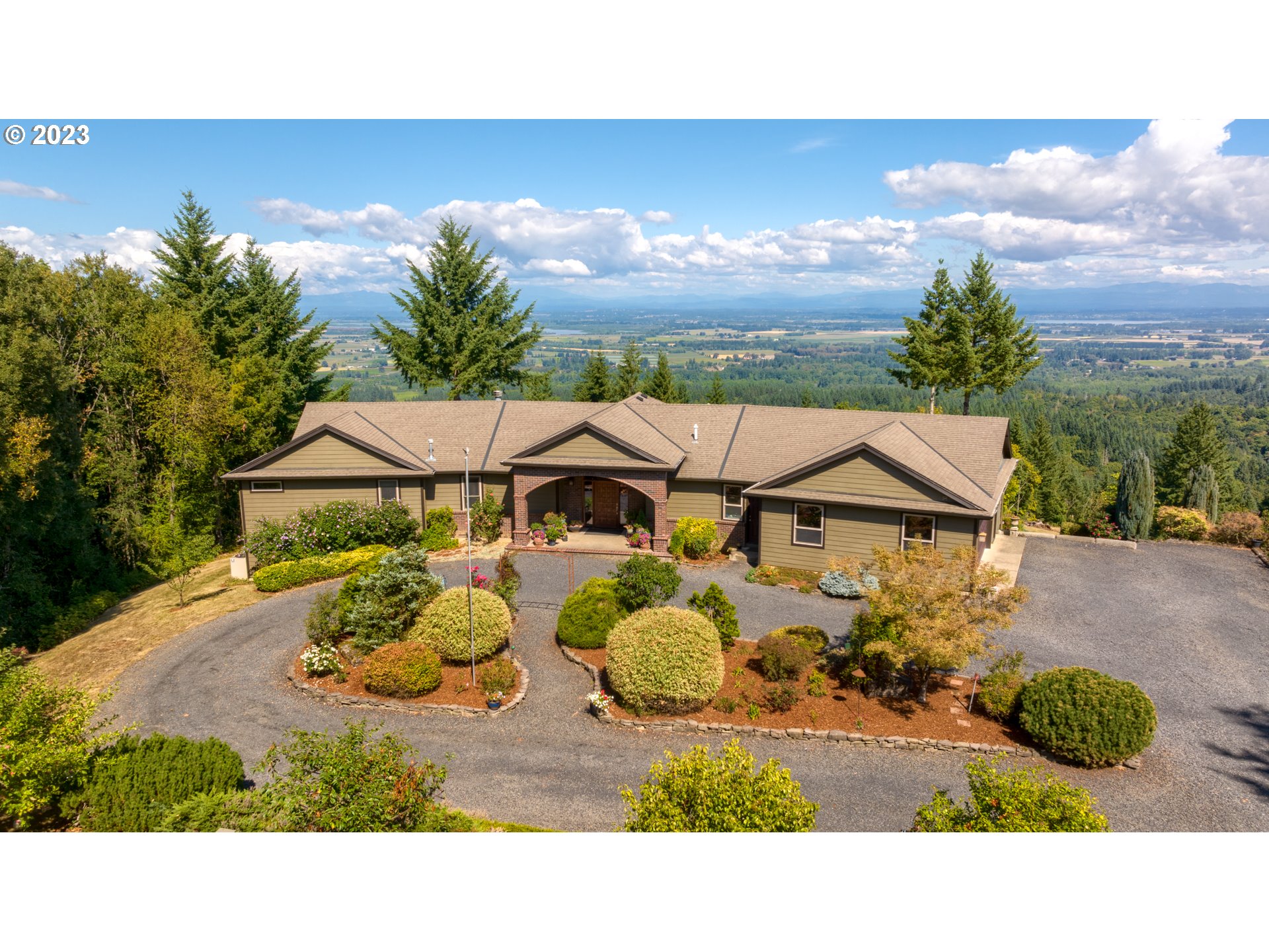 As you drive down the 1500 ft driveway, your stress level will begin to fade as you see hints of the stunning views yet to come. Once inside the custom-built contemporary home on 18.79 beautiful acres, you'll experience privacy and peace from the views of five mountains, lakes, ships on the Columbia and Willamette Rivers, sailboats on the Multnomah Channel and the patchwork of farms, including pumpkin fields, on Sauvie Island. The main-floor living provides a circular window seat for wildlife viewing, a chef's kitchen with two ovens and two sinks. A slider from the kitchen / dining area opens to the deck where hummingbirds hover. Primary bedroom suite, laundry and office are conveniently on the first level along with a full mudroom with doggie shower. The lower level, with the same spectacular views, offers multiple bedrooms, a full bath, and a living area with fireplace. That area is pre-plumbed for a kitchenette or wet bar. There's also lots of storage space and an exterior entrance. Outside is a 700sqft detached shop, storage building for lawn mowers, tractors, garden supplies. Fruit trees abound and there is ample room for vegetable or flower gardens. The fir forest attracts many birds, elk, deer and other wildlife. Easy commute to Intel, Nike, Hillsboro, Beaverton, shopping and libraries. It's the perfect, permanent, peaceful getaway for you and your family. Warning: visitors never want to leave!