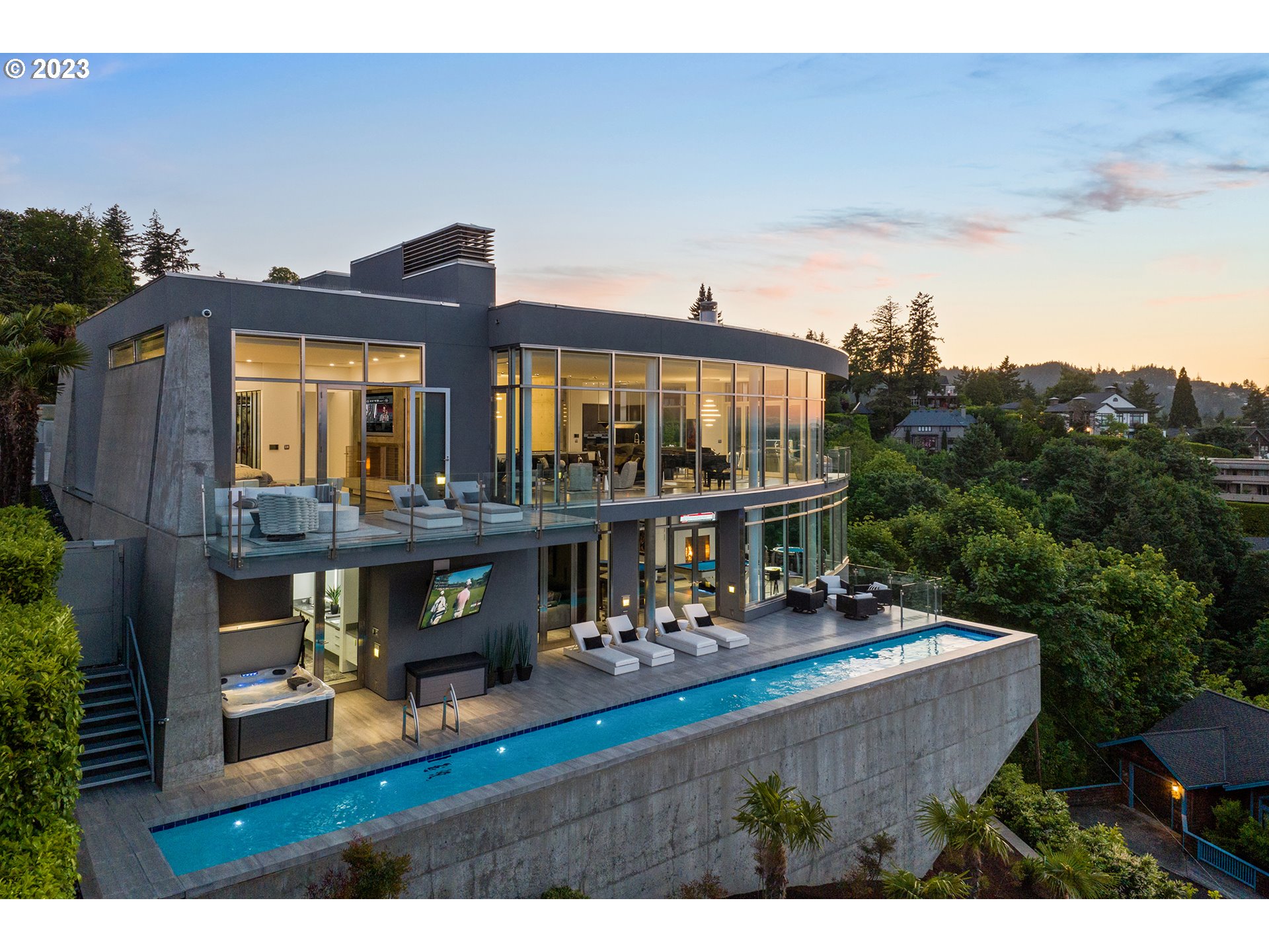 Ultra-Modern, private, gated sophisticate that is beyond the imagination. Since the last time this home was on the market over $1.7M has been invested and the price has been reduced by $1M..So, opportunity is knocking, you will want to own one of Portland's most iconic domiciles. This is truly one of one. Walls of glass bring the 270-degree views of the city, river, mountains and beyond to you. This showpiece encompasses elements not found in this marketplace. German engineered stainless steel front door and window package, imported stone slabs, imported Italian stone floors throughout the interior, exterior and surrounding the pool; custom designed elements that can be found nowhere else;  3BR 3.1 baths with a main floor Owner's Suite; elevator, gourmet kitchen, full bar, all new audio and AV throughout, media room with 140 inch screen, world class gym, guest suite, game area, state of the art LED lit wine cellar, pool bath with steam and sauna, full lap pool hanging over the city and 3-vehicle garage. This type of residence is something that rarely comes available and will stand the test of time in quality, style and functionality. Located just 2 minutes from downtown Portland and freeways. Over time over $15M has been invested in this home.