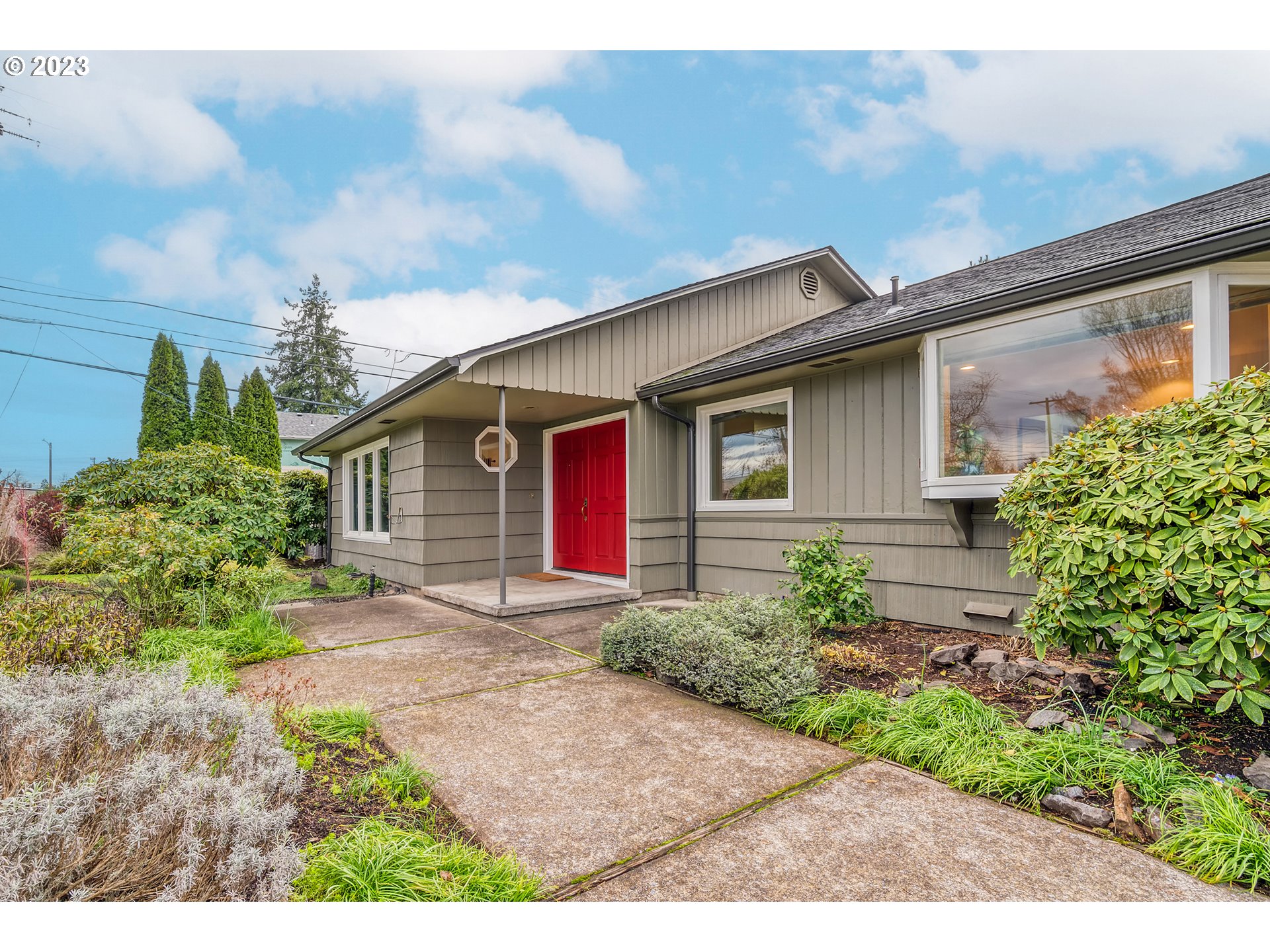 This charmingly crafted 1950s country ranch-style home sits on nearly half an acre, centrally located in town.Offering single-level living with an open layout seamlessly connecting the living, dining, and kitchen spaces. With rich hardwood flooring, as well as fresh white paint throughout, you'll find a a classic backdrop for your life.A spacious master bedroom awaits with an accessible soaking tub in the ensuite bathroom. The fourth bedroom could flex as a bedroom or office. There are thoughtful built-ins throughout the home and a convenient interior laundry room. A sprawling 31' x 14' covered patio is the perfect spot to relax and enjoy the views of the beautifully landscaped back yard, with a greenhouse, raised beds, and mature plantings. The expansive 50' x 24' shop has endless possibilities for business, hobbies, and storage, as well as potential for development, buyer due diligence. The shop has a 10 x 10 RV garage door, a versatile shop-office/studio, and adjacent and ample hard-surface parking which is accessible through a large side yard gate. This property is a harmonious blend of timeless charm and modern living.