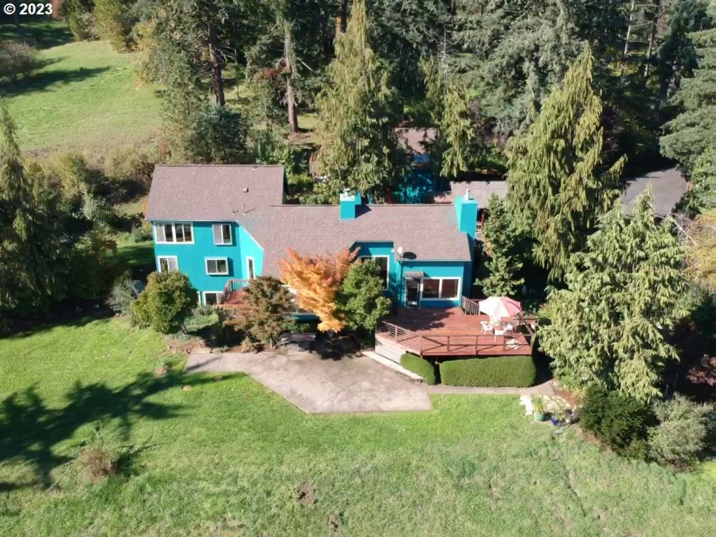 Located just minutes to town in exclusive Dillard Highlands, this Northwest Contemporary home on nearly 6 acres is designed to take maximum advantage of Cascade Range views and is ideally located down a private dead end road. One of the only houses in its area that does not have HOA and has its on private water well.This open and bright multi-level 4 bedroom, 3.5 bath home features walls of glass that frame the spectacular panoramic views throughout. A 500+ sqft studio space detached from the main house could be the ultimate office/workout room, art studio, study or turned into a guest quarters.  A second garage with attached shop is the perfect place for your hobbies or toys.  The beautifully appointed interior, with hardwood floors, furniture-like cabinetry, and built-ins throughout, will please the most particular tastes. Property has a large cedar green house that is set up with raised beds to have a large garden. The grounds far exceed expectations, with an exquisite flower garden, 15 year grapevines, waterfall, large Koi pond, vegetable garden, 50 years established orchard and meadow. House was laid out and built with feng shui in mind, upon entrance on the North has a 5000 gallon stocked KOI pond w/ waterfalls, property was cherry picked before neighborhood was built out for its prime location on SE facing hillside.