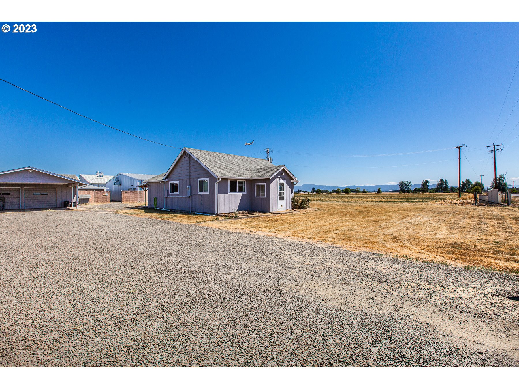 PRICE REDUCED!! Seller offering a $30,000 credit towards buyer's closing costs and interest rate buy down. This property features 10 acres of land, commercial water rights, and approximately 9300 sq ft of warehouse space across 3 separate buildings.  2 are newer construction w/ a 4200 sq ft bldg., (Bldg1) consisting of two 1200 sq ft rooms, one 1400 sq ft room, & one 400 sq ft work room, and a 3600 sq ft bldg., (Bldg2) which has four 960 sq ft rooms, one of which has a sectioned off office space of 170 sq ft.  The last bldg., (Bldg3) is approx. 1200 sq ft and has been recently rebuilt inside w/ total insulation package. All warehouse rooms have Quest dehumidifiers, and full HVAC systems. Bldg. 1 has (2) 5 ton Trane HVAC systems in two rooms, and (1) 5 ton Trane HVAC system in the other large room. Bldg. 2 has (3) new 3 ton Daiken ductless systems in three rooms, and a new 2 ton Daiken ductless in the 4th room. Bldg. 3 has (1)  3 ton Daiken ductless system.  All buildings have water to them including automated systems in Bldgs. 1 & 2.There is a huge surplus of power onsite including 1800 available amps @ 277/480v (Bldg1), and 600 available amps @ 120/240v (Bldg2). Bldg. 3 shares a 200 amp comm Bldg. 3 shares a 200 amp common residential supply.   There is an updated two bedroom one and one half bathroom 1008 sq ft stick built home w/ a Mitsubishi ductless HVAC system, new engineered flooring and carpeting, double pane windows, dining nook, a large kitchen w/ granite countertops, lots of cupboard space, a large laundry room w/ loads of storage, covered deck, shed, a double car garage and carport. There is room for substantial growth on site with plenty of space for more warehouses and plenty of land to expand into. All of this in a great location in Eugene Oregon! Existing business can be purchased with sale for additional price.  This would be a great spot for manufacturing/distribution center, storage, farming, event center, hydroponics, brewery, winery or cannabis!