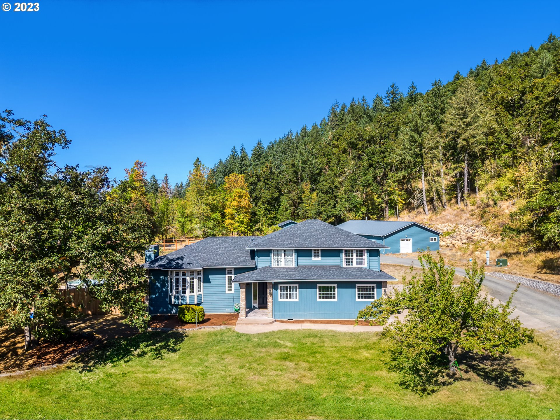 33345 IDYLLWILD RD Creswell, Oregon This Gorgeous custom home on 5 serene acres is sure to please! Enjoy quiet country living just a couple minutes' drive from the charming town center of Creswell. New 60' x 40' shop features dedicated 200-amp, heating/cooling, hardwired air compressor and a 500-gallon propane tank. High ceilings and spacious rooms await in the beautifully updated home. Modern kitchen with Quartz countertops, cook island and ample cabinet space. The formal dining room with French doors to the deck also has space for a large dining table, perfect for entertaining! Huge living room with great natural lighting and a fireplace. The main level also features a Family room with a wet bar and an office. 4 spacious bedrooms are found on the second level. The primary suite features a walk in closet, dbl sinks and a huge, tiled shower. Exterior features a spacious deck, fenced yard, mature oak trees and tons of space for parking. Newer roof, windows, electrical panel & HVAC.