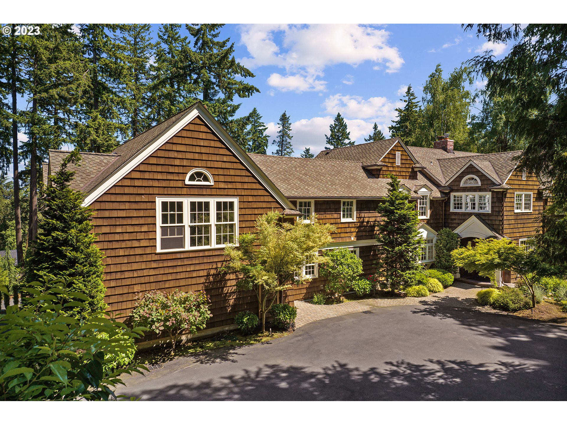1962 S MILITARY RD Portland, Oregon This gorgeous, classically-updated 1920s Dunthorpe estate is nestled on a large, gated lot that ensures maximum privacy.At the heart of the home, the gourmet kitchen offers cabinet-faced appliances, marble countertops, a 5-burner Wolf range, farmhouse sink, and a large butcher block island. French doors allow direct access from the kitchen to the back patio, a convenient layout for entertaining and outdoor dining.Adjacent to the kitchen, the formal dining area, accented by coffered ceilings with recessed lighting and a large bay window, is perfect for memorable gatherings with friends and family. After dinner, retire to the light-filled living room, anchored by a marble fireplace. Dual sets of French doors lead to the back patio, seamlessly blending indoor and outdoor living. For more casual gatherings, the cozy family room boasts oversized windows, vaulted ceilings, and an additional marble fireplace. The southern wing of the home houses a unique home office setup, complete with a gas fireplace and built-in shelving.Upstairs, a sprawling recreation area affords more than 1,000 square feet of play space with vaulted ceilings, a basketball hoop, and an entertainment room. On the opposite wing, the primary suite features stunning views of Mt. Hood, a fireplace, access to a private balcony, a spacious walk-in closet, and a luxurious en suite bath with deep soaking tub and dual-head walk-in shower. Four bedrooms, two full baths, and a laundry room complete the upper floor, while an additional lower level offers abundant storage.Along the rear of the home, an expansive brick patio sets the stage for outdoor entertaining. Multiple seating areas, a dining space, grill station, and fire pit overlook the rolling lawn.The front yard is equally captivating, boasting a custom cascading water feature and pond encircled by lush landscaping.Located in the prestigious Riverdale school district, just minutes from Lake Oswego and downtown Portland.