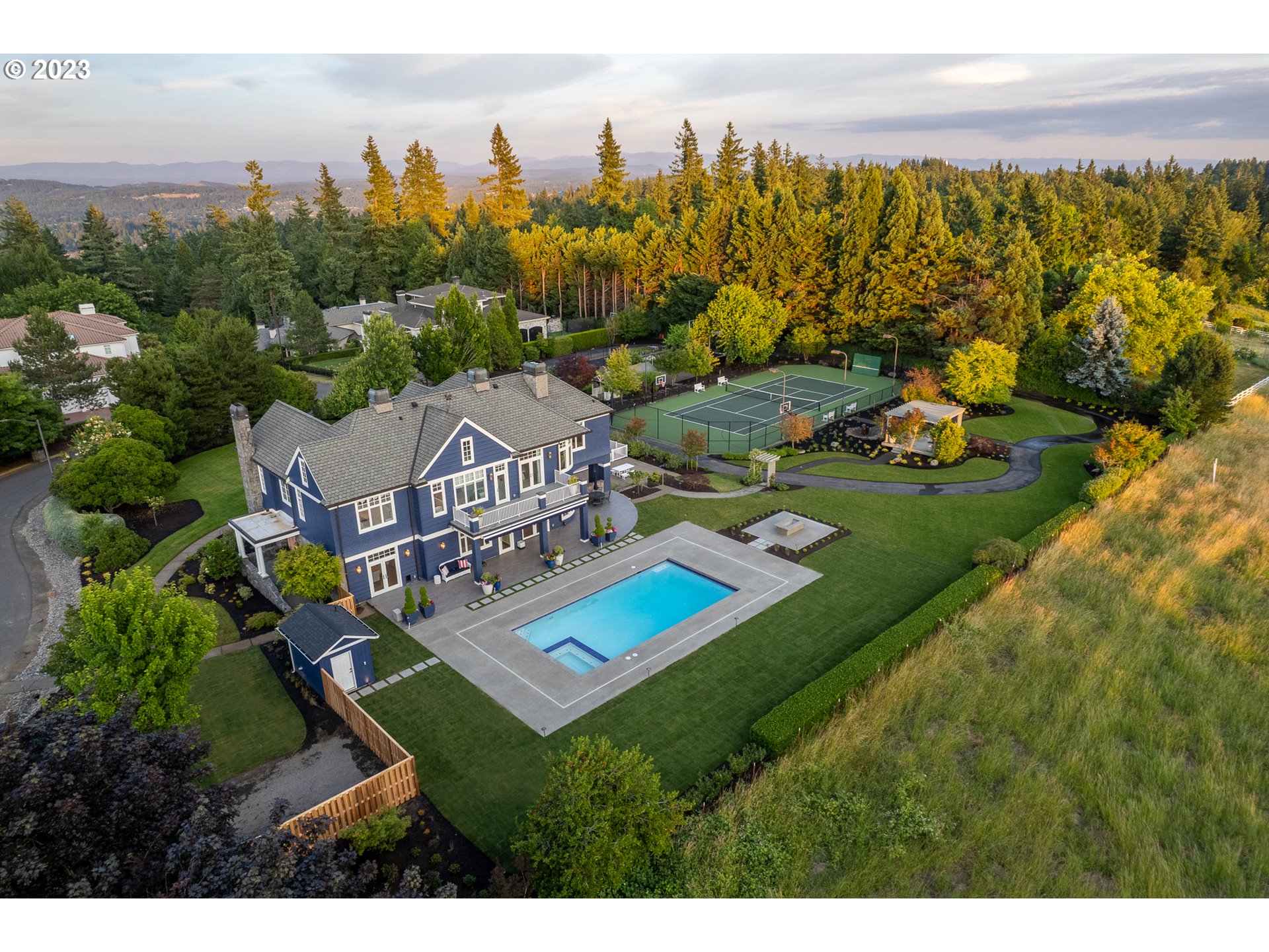 The epic Lake Oswego luxury lifestyle awaits in this pictorial Cape Cod wellness estate situated on 1 3/4 acres high atop the celebrated Skylands neighborhood! Revel in a newly installed 20x40' pool and spa gazing over staggering sunset and coastal range views, and surrounded by pristine patios, verdant lawns, a fire pit, gazebo, a regulation sized tennis/sport court, and 1/8 mile track - perfect for the outdoor lifestyle! Inside you'll delight in rich hardwoods, soaring ceilings, integrated Control4 whole-home technology, fine designer finishes, and 2 stunning great rooms accessing the private lawns and covered pool verandas. The gourmet kitchen featuring Wolf and Miele appliances and the generous 2nd dining space opening to the relaxing family room that overlooks the pool and unmatched grounds. You'll have absolutely every amenity imaginable with 2 main level executive offices, a wine cellar, generator, bonus craft and media rooms, and 5 gorgeous bedroom suites. The splendid primary suite enjoys the expansive views and a private balcony, heated spa bathroom floors, and pedestal tub. While guest and family accommodations abound, this wonderfully warm and welcoming home lives with all the comfort and elegant grace of a beloved legacy estate. Create culinary magic from the fenced kitchen gardens and raised beds. Make a lifetime of memories with summer parties, holiday retreats, and milestone events in this marvelous estate.