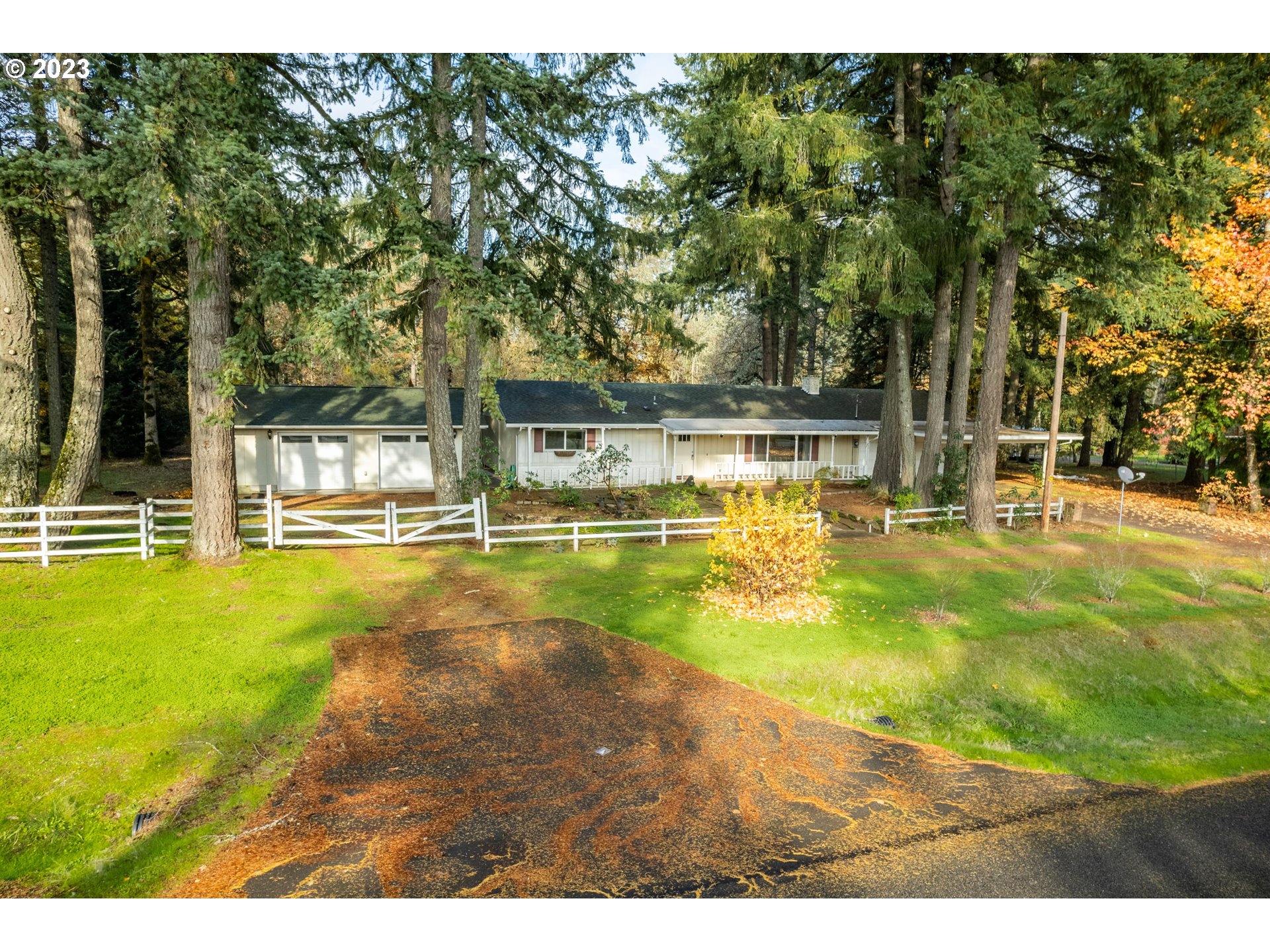 This is the one-level country home you have been looking for! On almost 1 acre, you get the rural lifestyle plus sense of spaciousness and privacy without all the upkeep. Besides the beautiful setting, the main highlight of this home is the stunning, wood-lined, open-beam, vaulted ceiling that runs throughout the entire house and into the 672 sqft garage, allowing for the possibility of a beautiful and cohesive expansion. The spacious living room features an oversized, south-facing picture window and a wood-burning fireplace leading into the dining area with a slider to the back and kitchen with granite counters, eating bar & newer appliances, all included. This home features 3 bedrooms and 2 full bathrooms...the primary bedroom ensuite has double closets and attached bath. Outside you will find a 720 sqft detached shop (in addition to the covered carport and huge attached garage!) with heat, electricity and skylights plus 2 small outbuildings, hot tub, beautiful landscaping, tons of mature trees and plants and shrubs. Don't miss the two convenient driveways and multiple spaces to park an RV, boat, trailer and lots of vehicles. Also features new interior paint, newer vinyl windows, newer doors, newer well pump, Culligan whole house water filter, 2-head ductless heat pump system, tons of built-in storage in the garage and shop and sweet covered porches in front and back. This property is definitely worth the short drive...only 3 minutes to Fern Ridge, 6 minutes to Veneta, 12 minutes to Jerry's Home Improvement and 20 minutes to Costco!