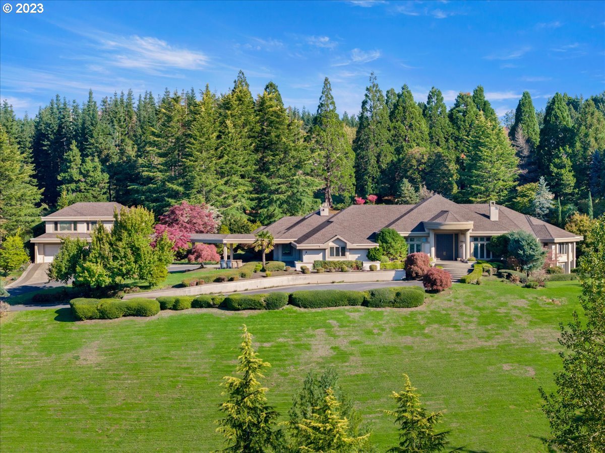A private, gated estate with luxurious potential, with a self contained guest house just minutes from downtown Lake Oswego on a private 10 acres with beautiful views. The home offers formal & casual entertaining spaces both inside and out; Gourmet kitchen with granite, professional-grade stainless steel appliances and oversized island; Indoor pool with hot tub, kitchenette & full bath; Two large primary suites on the main level; Sound-proof theater room. The property offers the potential for a vineyard with southern exposure. The property is very private with natural spring/creek, meadow, trails and lots of room to play!6 Bedrooms, 6.1 baths, theater room, library, indoor pool/spa, 7 garage spaces and guest house.