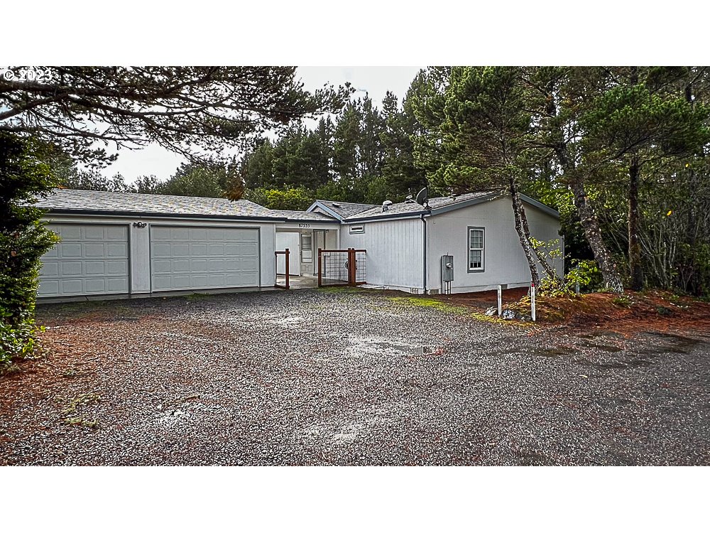 This move-in-ready house is a must-see! Situated near the beach and town this is a private lot separated from the main road by natural vegetation making this a welcoming private retreat. The .36-acre flat lot with a metal RV/Boat carport and a large detached 2-car garage is connected by a breezeway over a concrete pad to the house. The house has fresh interior paint, new carpet throughout, and a new stainless-steel range. The large kitchen features an island for additional working space and storage with a skylight for natural lighting. The main bedroom has a walk-in closet and a bathroom with a shower and linen closet. The additional bedrooms are on the opposite end of the home and are separated by the dining area and large living room space. The utility room has space for a washer and dryer and a large sink.  The second bathroom with a tub connects to the utility room and the bedrooms. There is a fenced yard off the breezeway and behind the garage.  Remove shoes for showings please.