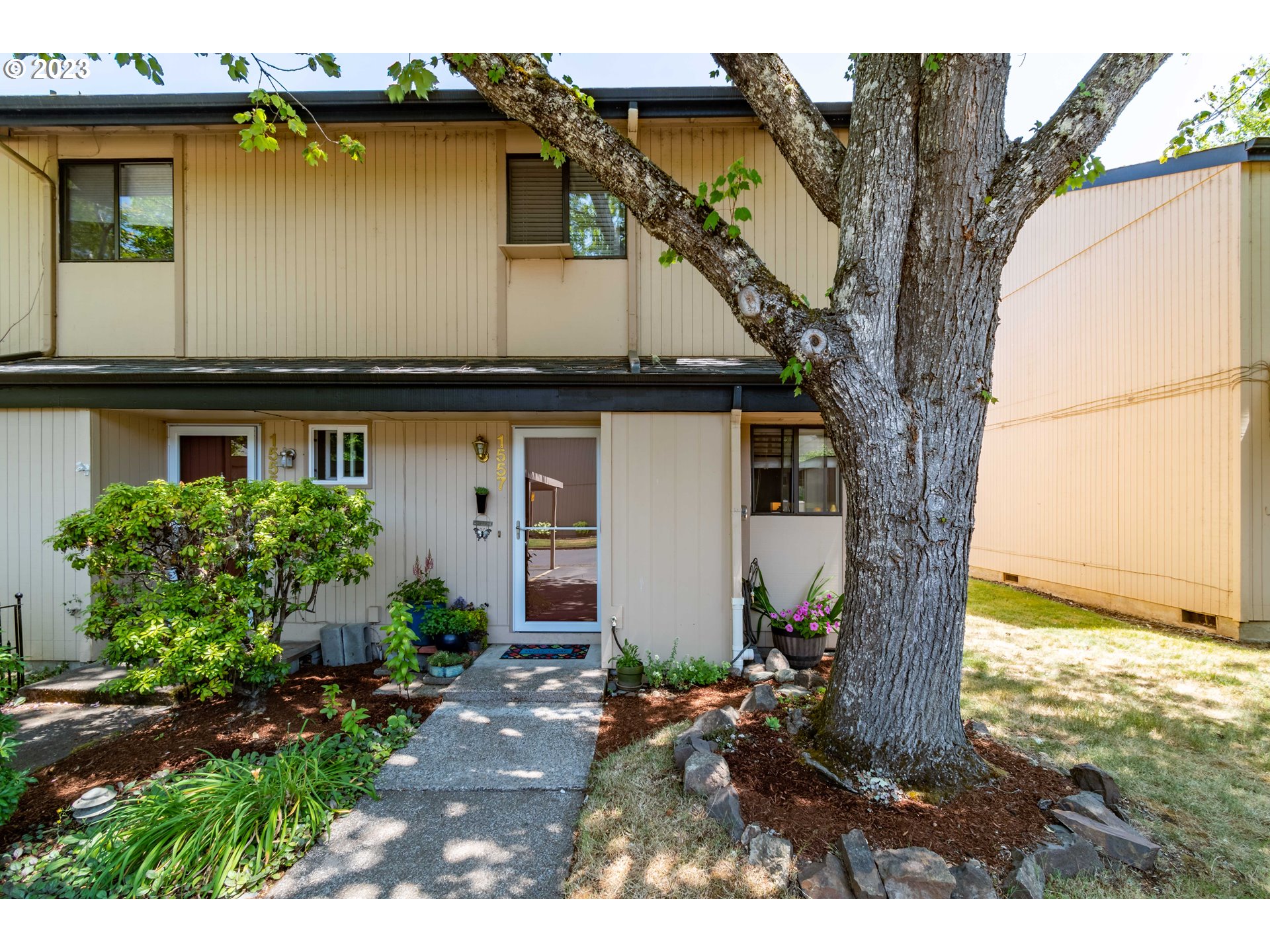 Well maintained end unit on the quiet backside of the complex. Open floorplan featuring a living room with wood-burning fireplace & slider to patio w/a privacy fence and adjacent grassy common area, compact/convenient kitchen with some newer appliances, closet with full-size stacking washer/dryer, large loft-style bedroom ensuite with newer tub/shower and flooring. Assigned carport, storage off carport and patio. Well manicured grounds, common areas, garden, and pool. Close to shopping, bus and schools. HOA includes garbage, siding, roof, maintenance of common area, garbage, pool, & community garden.