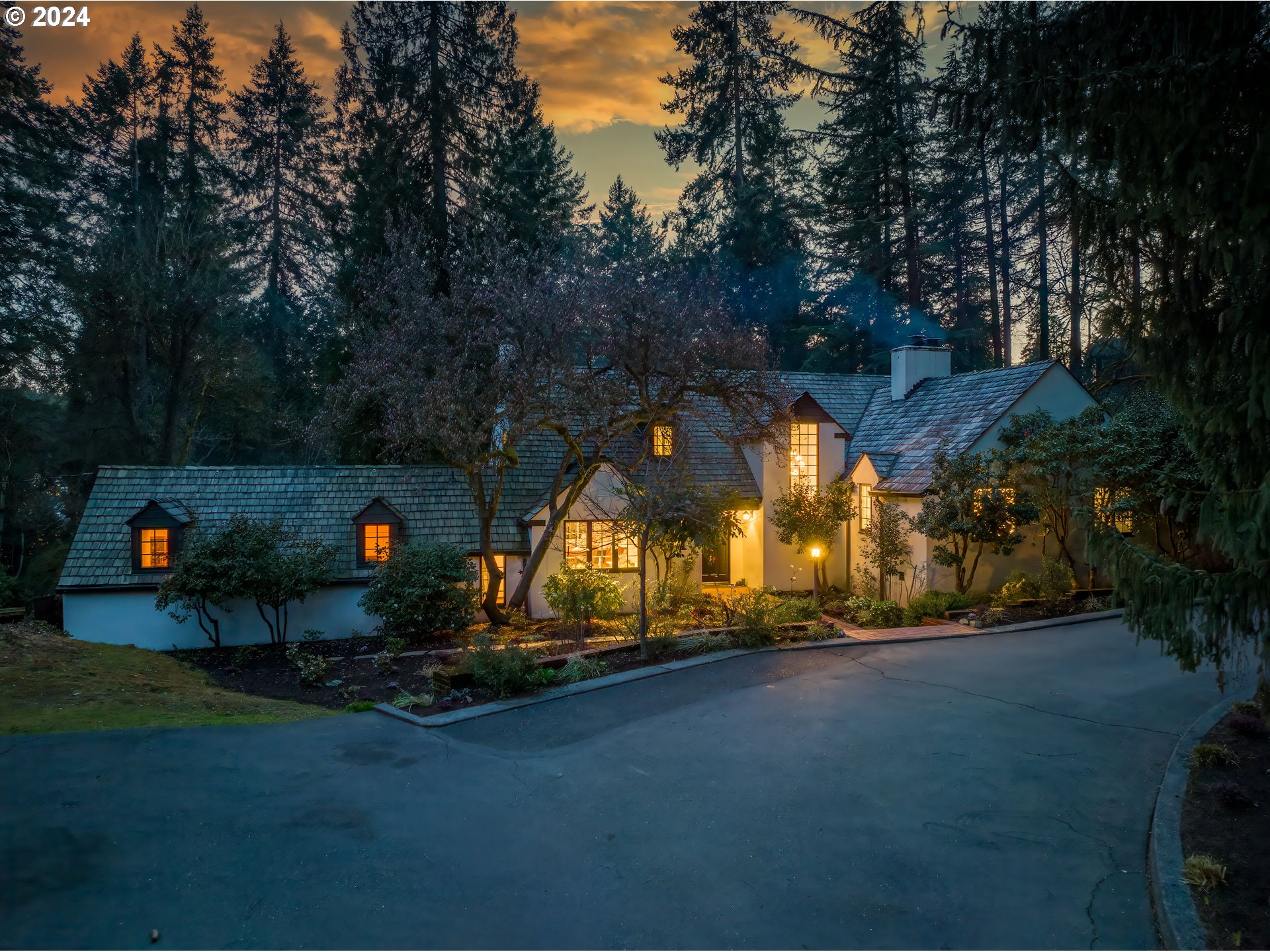 Historical Country Club estate with historical interest rate opportunity. 2.625% assumable loan for qualified buyers. Nestled within Lake Oswego's esteemed Country Club district, this venerable, nearly 100-year-old home is a timeless testament to luxury living, steeped in rich history and meticulously reimagined for modern comfort. Designed by renowned architect Richard Sundeleaf in 1936, this English farmhouse-inspired estate was built on the site of an iron ore quarry and the resulting amphitheater-like surroundings are a spectacular, unmatched, nearly 1 acre private setting. Recently reimagined to perfection, every detail of its Tudor-influenced design has been thoughtfully preserved, from the stucco exterior to the steeply-pitched gables and half-timbering. This home is a seamless blend of classic elegance and contemporary amenities, including an English manor-inspired kitchen, a sunlit dining room, and two primary suites. Situated just minutes from downtown LO, top-rated schools, and outdoor recreation, walking distance to the Forest Hills easement, this exceptional property offers an unmatched opportunity to experience the epitome of Lake Oswego living.
