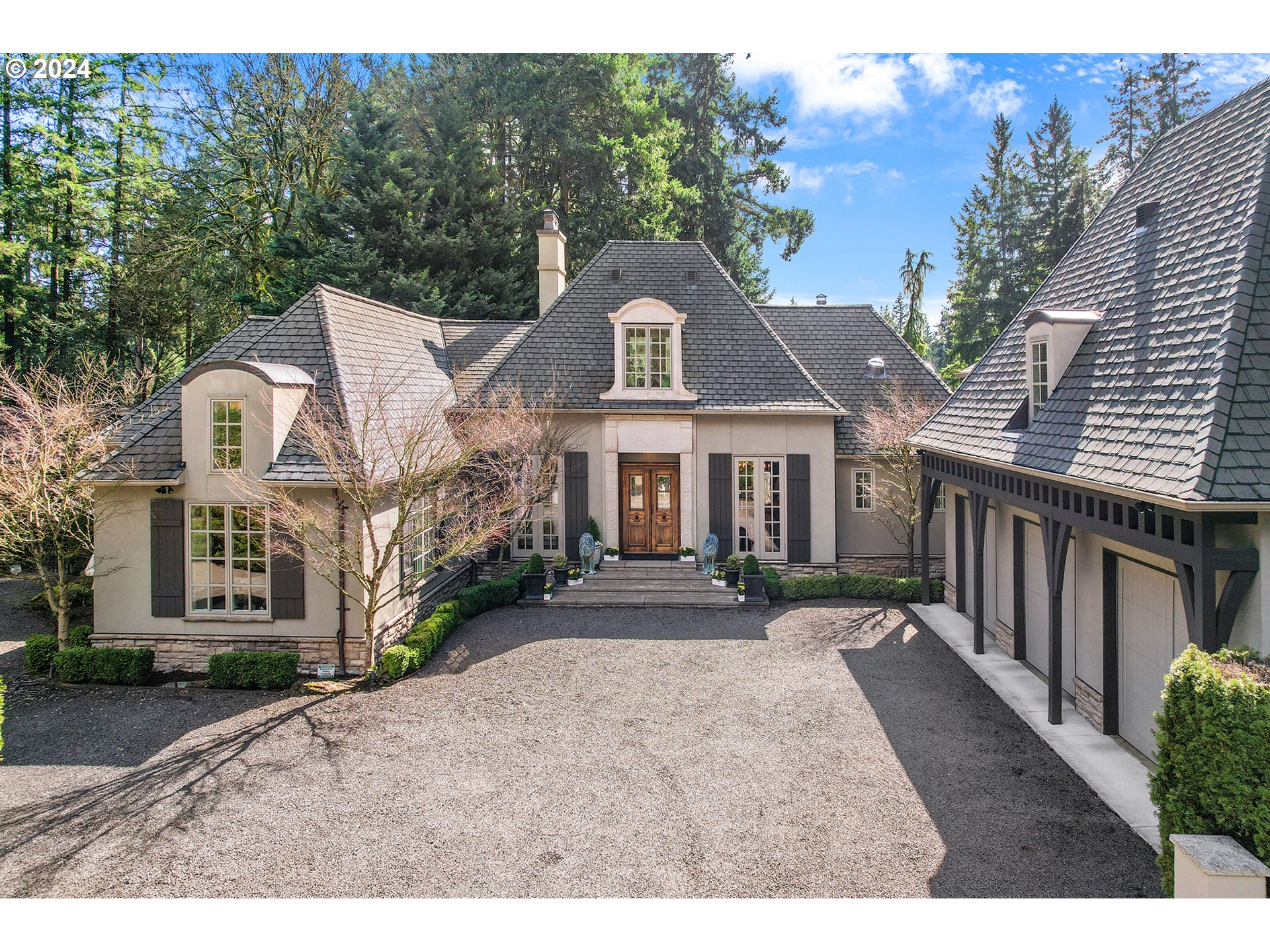 Location, Location, Location! This French Chateau-inspired estate is situated in the heart of Lake Oswego near the Downtown area with wonderful restaurants, shops & local businesses. The Oswego Lake Country Club is down the road and there are many trails and parks nearby. Forest Hills Lake Easement is a short walk & enjoyed with deeded access. In addition to being surrounded by other magnificent homes, this one-of-a-kind Estate has been renovated to the twenties in line with Chateauesque architecture; no detail has been overlooked. With antiques and imported pieces throughout, this home tells a story. After entering the courtyard through the electronic gates, you will begin to see the elegance of the home. Through the 300-year-old, imported wooden doors, open sight lines and natural light take you beyond the great room out to the breathtaking gardens, complete with raised beds and complimented by the sound of the water feature just beyond. This home combines sophistication and warmth. The owner's suite is on the main floor with French doors that lead to the gardens. The bathroom is exquisite with marble finishes, custom built-in cabinets, and a closet beyond words. Two additional bedrooms & a bathroom are upstairs. Guest quarters on the opposite side of the home with a bedroom, sitting area, full bathroom & laundry accommodations. The exceptional gourmet kitchen is complete with Danby marble that extends beyond the counters and up the walls. Beautiful custom cabinets with many built-ins provide extensive storage. The light fixtures throughout are exquisite. Beyond the kitchen & through the French doors, you will enjoy a charming, covered patio with beautiful lighting, overhead heaters, and a fireplace complete with gas logs. It can be enjoyed all year long. This beautifully designed area of the nearly half acre property overlooks the gardens and offers a sense of peace & serenity, a true piece of paradise.