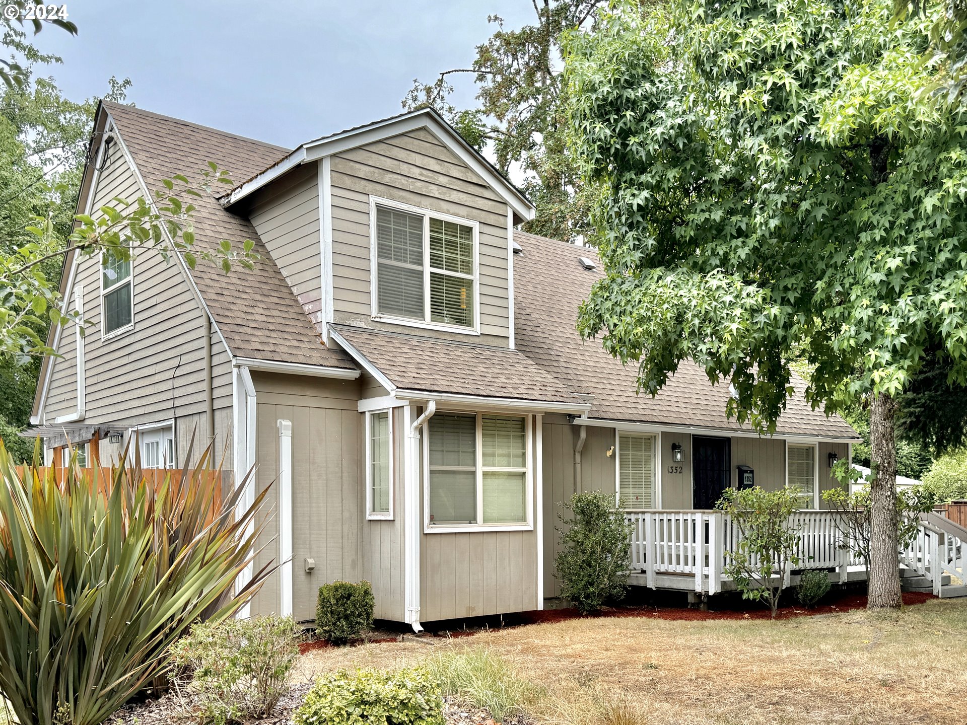 This inviting vintage charmer has modern updates and sits on a huge corner lot. A sweet front porch and entry room welcomes you in. The kitchen has been updated with stainless appliances (all included), the cozy living room has French doors to the exterior, and there are 2 bedrooms and a full bath with walk-in shower on the main level. Upstairs you'll find a spacious light-filled primary bedroom suite with a sitting room, walk-in closet, and full bath with tub. The .2 acre lot offers beautiful trees, several kinds of fruit, raised beds, 2 small sheds, and a new 9x16 shed with double pane windows, great for your storage or shop needs. There is a chicken coop with an attached enclosure which connects to the home, the current owner used this as a "catio" for her indoor cat. It could easily be used for chickens, too. The backyard is fully fenced and has a large gravel pad with curb-cut access to the side street through a sliding gate. Perfect for your RV, boat, extra vehicle parking and has ADU potential. All this in a convenient location near a bus stop, close to restaurants, shopping, downtown Springfield, the public library, and Autzen Stadium. Seller states that Fiber Internet will be available in the area soon.