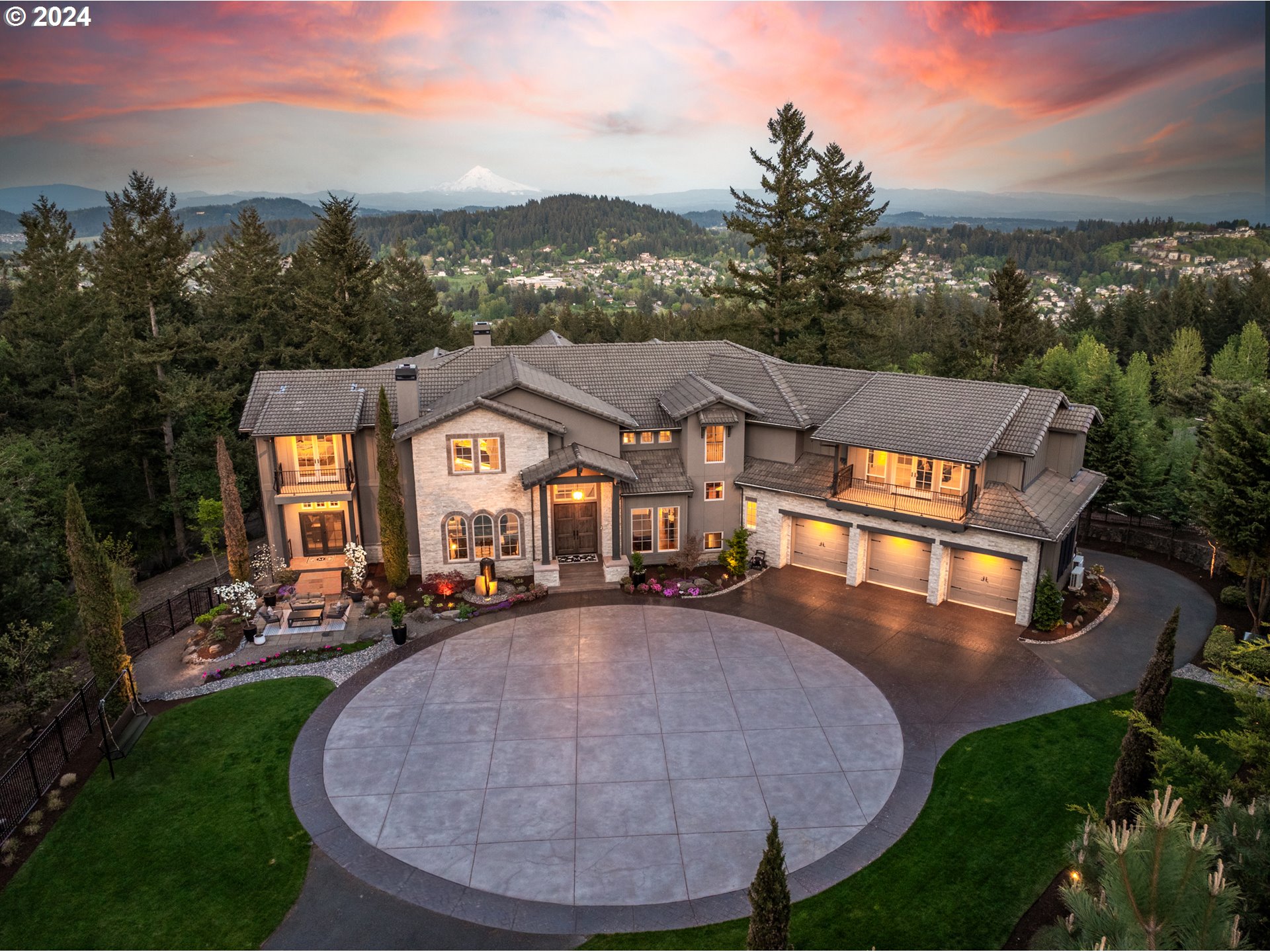 Redefining luxury living in every way, this magnificent custom estate was fully remodeled in 2022 sparing no expense or fine finish and creating a masterpiece to rival its breathtaking Mt Hood views! From the 3 floor elevator to the custom wine cellar and tasting room, private guest apartment, and exceptional high design/use of space, the home enchants at every turn. Wend your way down the private drive and through the gates to find a sleek yet welcoming contemporary refuge adorned with multiple view decks and patios that gaze over the pristine refinished pool and patio gazebo with fireplace. Through the soaring front doors you'll find Mt Hood framed like a work of art through walls of 2 story viewing windows, a spectacular great room with mezzanine landing, showcase kitchen with rich quartzite counters, formal dining with butler's pantry, billiards room with deck, and main level executive office/primary bedroom option with nearby bathroom. Dressed to delight from top to bottom, the enormous upper level primary getaway suite is finished with a sitting room, two fireplaces, glamorous bathroom with dressing room and 2 decks. Enjoy 3 additional plush suites upstairs and a spacious media room with deck. Downstairs you'll enter a world apart with incredible entertaining options including the family room opening to the pool patios, bonus/flex rooms, and full apartment featuring 2nd gourmet kitchen and private entrance. A auto collector's dream with 2 showroom garages offering 6-7 parking spaces and motorcourt, fitness studio, laundry on each level, gleaming hardwoods, up to 21 ft ceilings, and designer lighting - simply unforgettable with undeniable privacy and craftsmanship throughout!