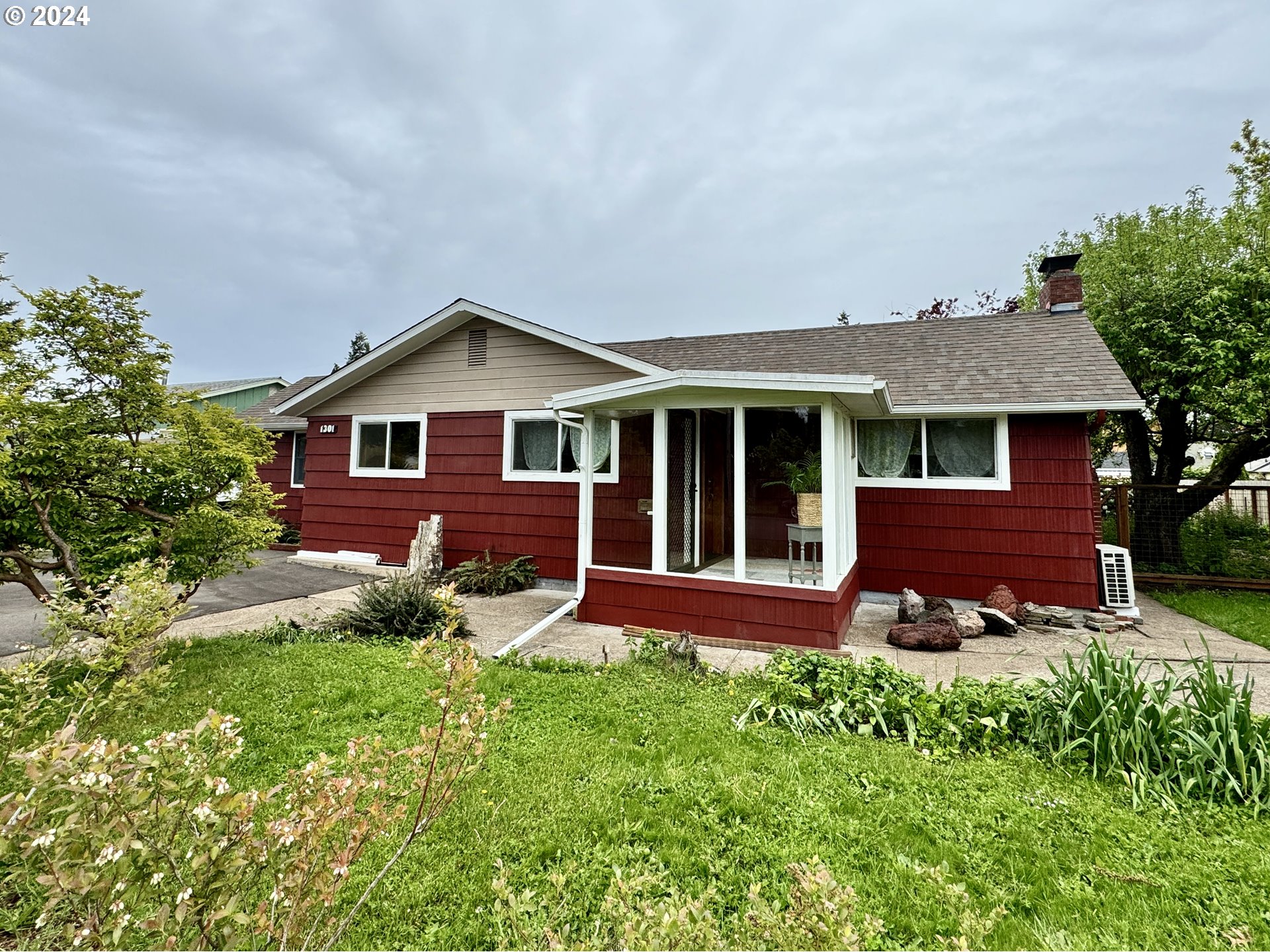 Lovely well-maintained home offers lots of vintage charm and character. Hints of yesteryear blend with modern updates to make this unique home fun and functional. Updates include exterior paint, electrical panel, fences, house vac, tub surround, and vinyl windows. Brand new carpeting in bedrooms and living room.Features such as the sun room entryway, wood accents and trim, natural light from large windows & a solar tube, and a brick fireplace with heatilator make this home inviting and warm. There's even an indoor cedar-lined sauna! There's an abundance of closets, book shelves, built-ins and a walk-in pantry which provide convenient and attractive storage solutions. A large mud room gives additional space. You'll appreciate the large .28 acre lot. A spacious covered deck overlooks the back yard gardens, which include a mature grape arbor, trees, flowers, organic raised beds, and features a rock garden with a 5 foot tall centerpiece of petrified wood. Enjoy Comise pears, apples, green and red grapes, rhubarb, and blueberries. The lot also has abundant parking, covered carport, shed, and a fully fenced backyard. ADU potential, buyer to do due diligence. Additionally, there's alley access to the garage, which includes a bonus room and certified wood stove. Would make a great shop, art studio, additional living space, etc. Great location near downtown, Washburne district, the hospital, and Willamalane.