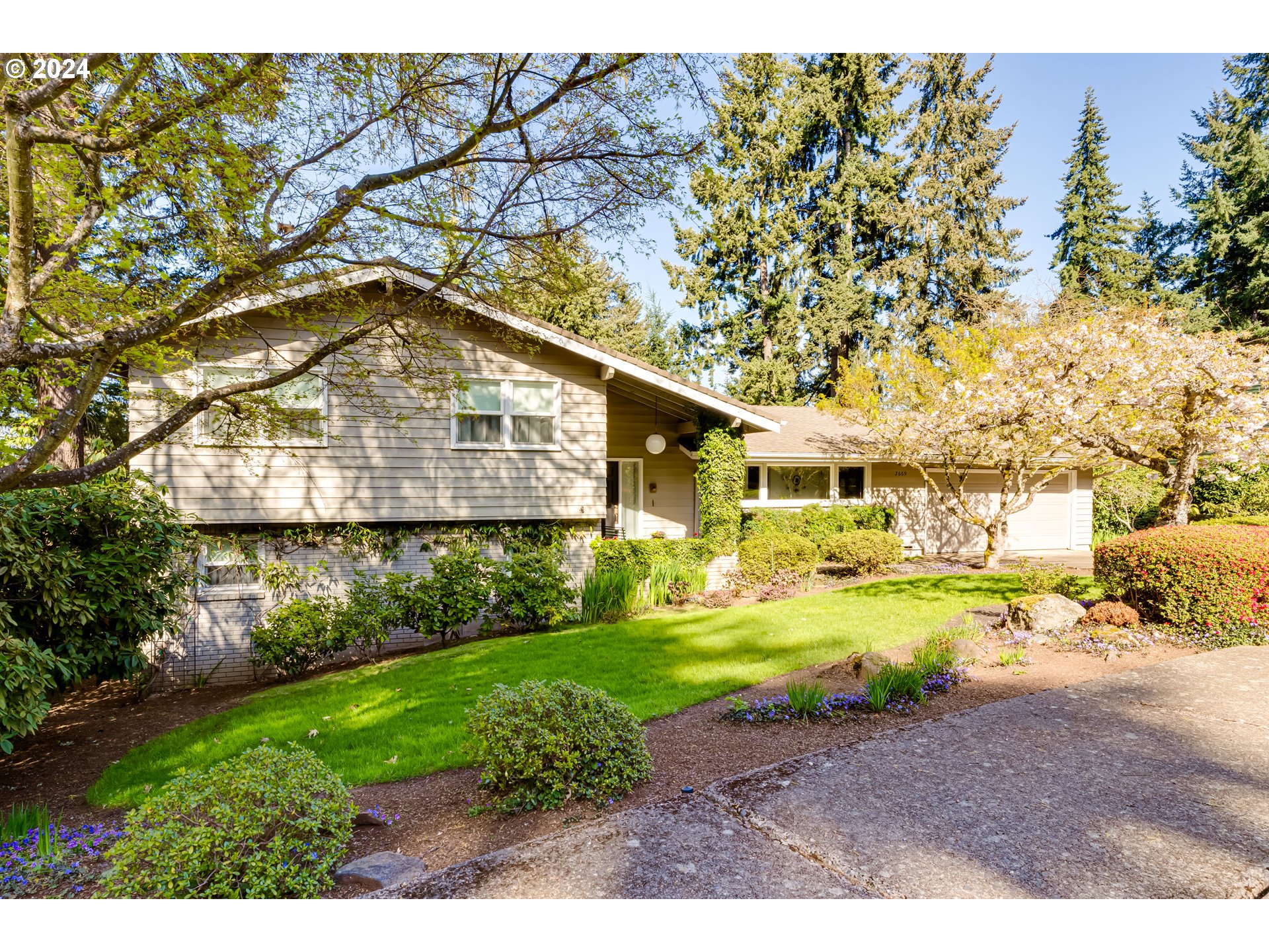 Discover the epitome of Pacific Northwest living in this immaculately cared for home in the coveted SW Hills. With quality hardwood flooring, large windows framing city views, and good separation of space, complemented by new HVAC and windows for efficiency, this residence offers both charm and functionality.  Enjoy the large fenced lot with pristine landscaping, underground sprinkler system and expansive decks offering more city and tree views.  The retro kitchen adds character to this well-maintained gem. All appliances included, making this home truly move in ready! Don't miss out on the opportunity to call this your home sweet home.