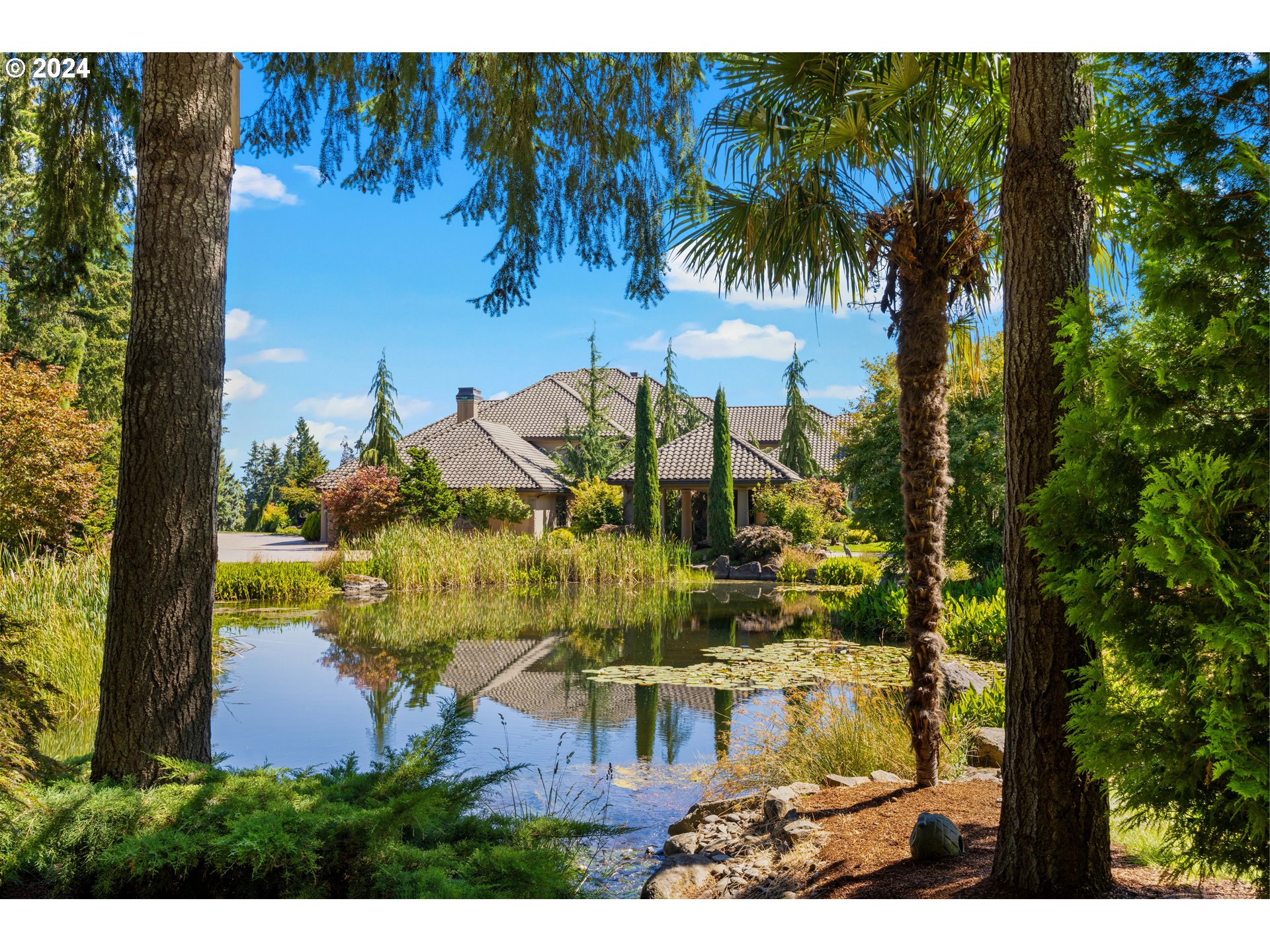 Spanning 20ac in West Linn, Oregon, this estate redefines opulence and serenity with a one-of-a-kind workshop. Bordering the scenic 15th & 16th fairways of the Oregon Golf Club, this custom-built 13,379sf estate, built in 2001, seamlessly blends traditional elegance with modern amenities. Perfect for car enthusiasts, golfers, and entertainers. Highlights include a grand library, Mt. Hood views, indoor & outdoor pools, main level  & upper level primary suites with dual bathrooms, plus three add’l ensuite bedrooms. And...a 16,143sf workshop (two full plus one half baths) with a built-in dyno (formerly the home of WW Hotrods), complete with a 1950s-style game-room, showroom, parts-room plus an apartment. The meticulous grounds boast streams, ponds, and a variety of trees/plants, creating a serene park-like setting. Add’l amenities include a 7,676sf warehouse for extra storage and three RV pads with full hookups. Located 30 minutes from downtown Portland and PDX airport, 20 minutes to Aurora airport/FBO and within 5-15 minutes to dining, shopping, Willamette River and a variety of tasting rooms (Willamette Valley AVA). This estate is the ultimate destination with unparalleled luxury in a stunning natural setting.