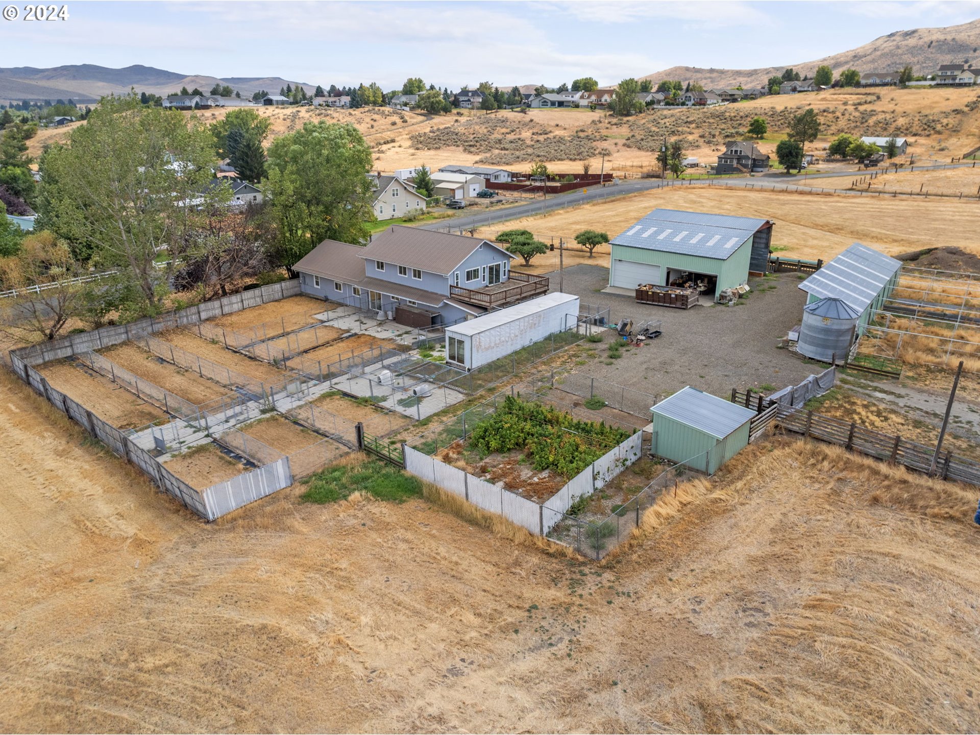 Located in the heart of historic Baker City, this 8.92-acre property offers a rare and exciting development opportunity in Northeast Oregon. Previously utilized as a dog kennel and overnight boarding facility for cats, this expansive estate includes prime real estate with outbuildings that are perfect for repurposing, whether for residential, commercial, or agricultural use. Zoned for farm use and with no CC&Rs, the property is ideal for those interested in subdividing or developing into a residential community or custom family estate.Built in 1920, the 3-bedroom home sits on nearly 9 acres of flat, usable land, offering an abundance of space and potential. Whether you’re looking to develop multiple homesites or create a private retreat, the property provides a blank canvas with endless possibilities. The peaceful, rural atmosphere is complemented by its convenient proximity to local schools, parks, and the amenities of Baker City.About Baker City: A Gateway to the Wild Beauty of Northeast OregonBaker City is a gem nestled in the high desert of Northeast Oregon, known for its rich history, outdoor recreation, and vibrant local community. As the gateway to the stunning Wallowa Mountains and the scenic Elkhorn Range, the area offers a wealth of recreational activities, from hiking and fishing to skiing and snowmobiling in the winter months. The city's charming downtown, listed on the National Register of Historic Places, boasts beautifully preserved architecture, art galleries, unique shops, and a growing food scene.For those looking for a development project or a spacious estate in a town with a deep sense of history and community, this property is a prime opportunity. Its combination of location, acreage, and development potential makes it one of the most attractive listings in the region.All offers will be reviewed by October 7th, with a seller move-out date of November 1st.