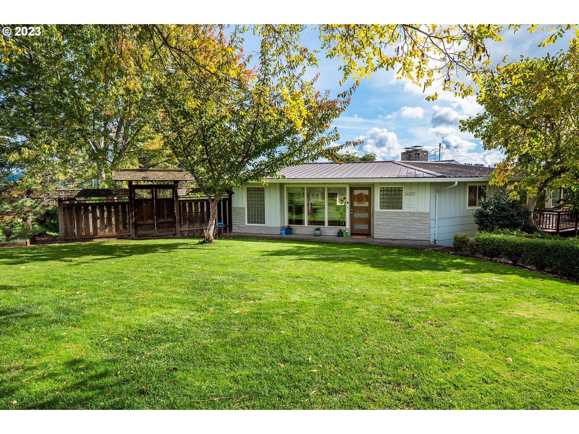 Mid-century stunner in desirable College Hill neighborhood! This wonderful home was thoughtfully restored and remodeled in 2019. You'll find tile and updated flooring throughout, in harmony with newer kitchen, bathrooms, electrical, and plumbing. Additional upgrades include a new furnace, driveway (last year), & sections of fence. The open floor plan is distinguished with custom blinds, entertainment bar, daylight basement/flex room for adults and kids, spacious utility and large south-facing deck (recently stained) with newer hot tub; perfect for relaxation or entertaining. Enclosed garage and carport make for easy access. Large adjacent fruit-producing orchard lot was purchased following the acquisition of the home, is HUGE, beautiful, and is included in this sale!