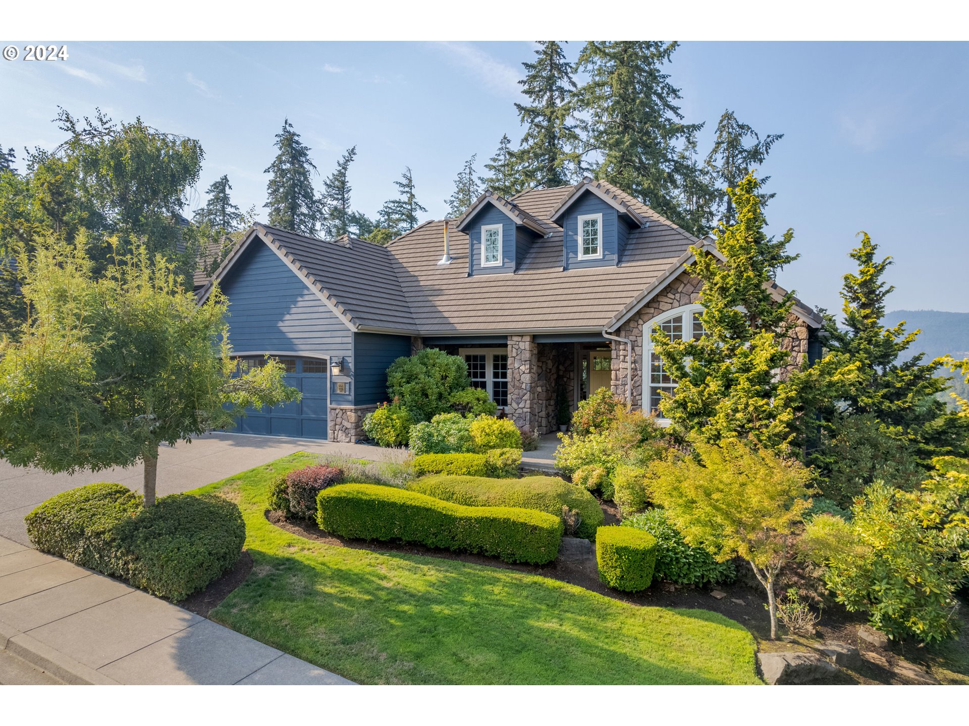 Open House Sunday 8/11 from 12-2pm! Gorgeous Mountaingate Craftsman, Designed & Built w/ Amazing Attention to Detail by Walter Custom Homes! The dramatic foyer with spacious office on the left and vaulted formal dining on the right will immediately welcome you but the sprawling and luxurious great room will make you never want to leave. With one of the best floor plans for entertaining, this home features panoramic valley views from the main living area that includes newly refinished hardwood beech floors, 10-foot ceilings, a stone-encased wood burning fireplace, easy access to freshly stained deck, and one of the most incredible kitchens out there. With timeless granite counters & cabinetry, stainless appliances, two islands, double wall ovens, gas range, walk-in pantry and butler's pantry, this kitchen will be sure to please the chef in your life. The almost 2600 sf on the main level also includes a luxurious primary bedroom w/ French Doors leading out to a private deck, and spacious tile bathroom w/ dual sinks, soaking tub, shower and walk-in closet.  The lower level features a cozy family room w/ gas fireplace leading out to a covered deck, 2 additional bedrooms, another full bathroom and an additional approx 1000 sqft of partially finished space that is not included in the total size of the home. This area encompasses a mudroom, arts & craft room, wine cellar, exercise room and a massive storage space. The private, .27 acre fenced yard features a magical wisteria-covered trellis around a waterfall pond w/ lily pads, pebble walkways and beautiful hydrangeas, lilacs and rhodies. Other features include a fully-equipped laundry room, finished 3-car garage, central vacuum, gas furnace, central A/C, underground sprinklers, freshly painted fiber-cement siding and tile roof. All this and located in the super-coveted, original Mountaingate neighborhood...ask your agent for a private tour today!